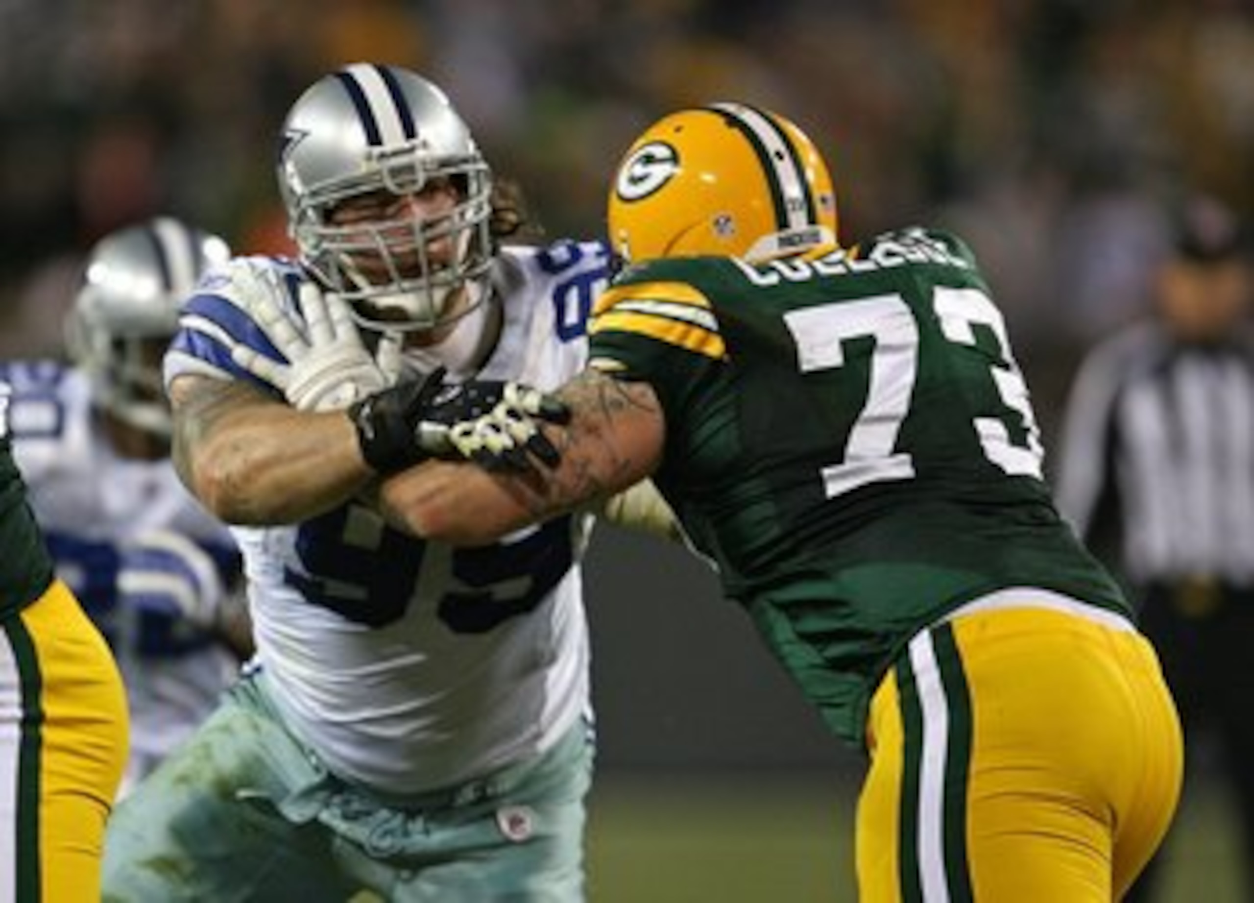 GREEN BAY, WI - NOVEMBER 15: Igor Olshansky #99 of the Dallas Cowboys rushes against Daryn Colledge #73 of the Green Bay Packers at Lambeau Field on November 15, 2009 in Green Bay, Wisconsin. The Packers defeated the Cowboys 17-7. (Photo by Jonathan Danie