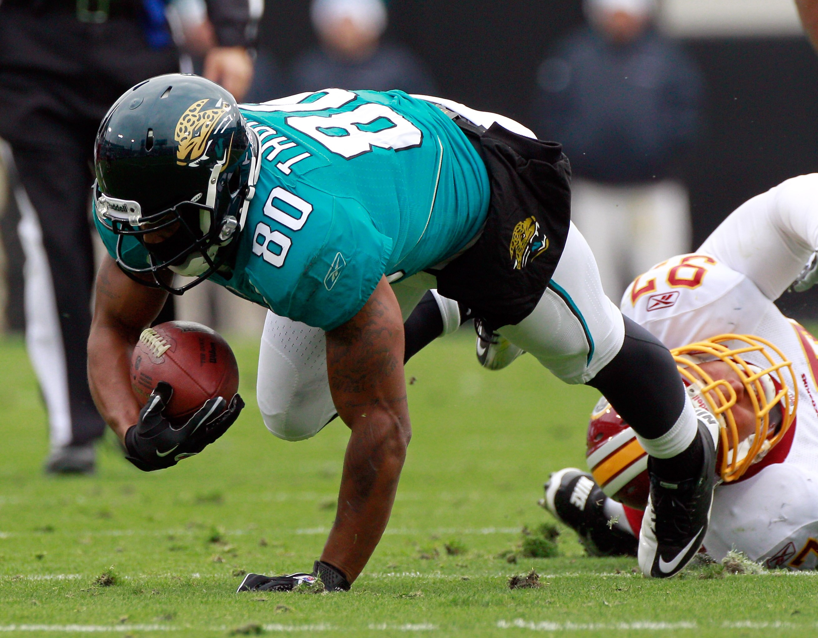 JACKSONVILLE, FL - DECEMBER 26:  Lorenzo Alexander #97 of the Washington Redskins attempts to tackle Mike Thomas #80 of the Jacksonville Jaguars during the game at EverBank Field on December 26, 2010 in Jacksonville, Florida.  (Photo by Sam Greenwood/Gett