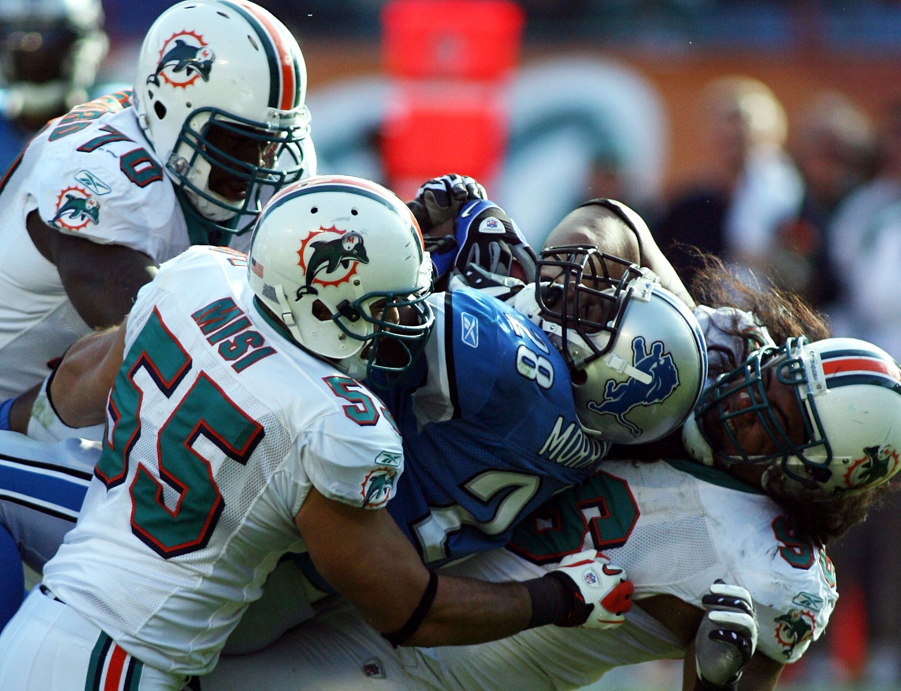 MIAMI - DECEMBER 26: Linaebacker Koa Misi #55 of the Miami Dolphins takes down running back Maurice morrice #28 of the Detroit Lions at Sun Life Stadium on December 26, 2010 in Miami, Florida. The Lions defeated the Dolphins 34-27. (Photo by Marc Serota/G