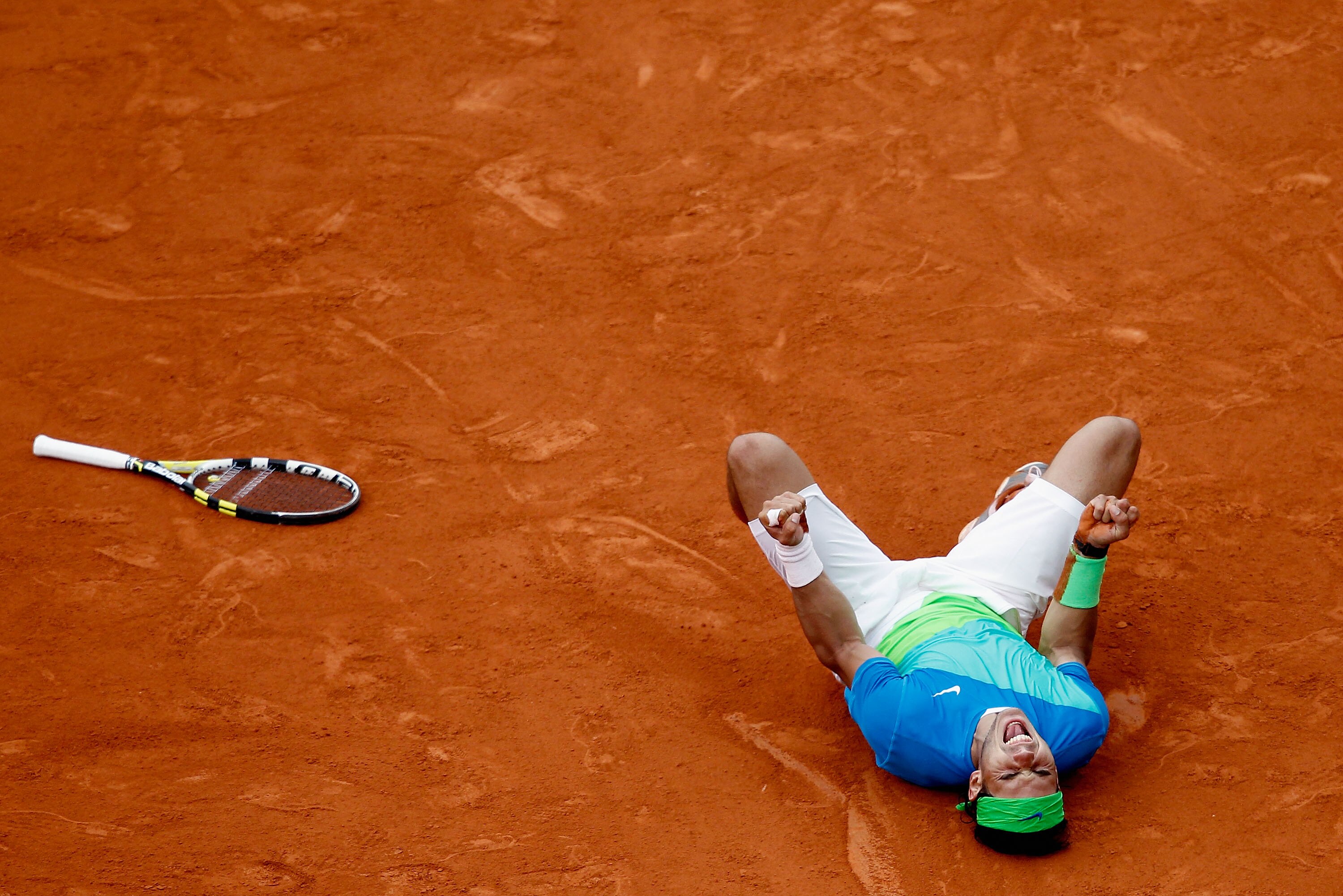 PARIS - JUNE 06: Rafael Nadal of Spain celebrates winning championship point during the men's singles final match between Rafael Nadal of Spain and Robin Soderling of Sweden on day fifteen of the French Open at Roland Garros on June 6, 2010 in Paris, Fra PARIS - JUNE 06: Rafael Nadal of Spain celebrates winning championship point during the men's singles final match between Rafael Nadal of Spain and Robin Soderling of Sweden on day fifteen of the French Open at Roland Garros on June 6, 2010 in Paris, Fra