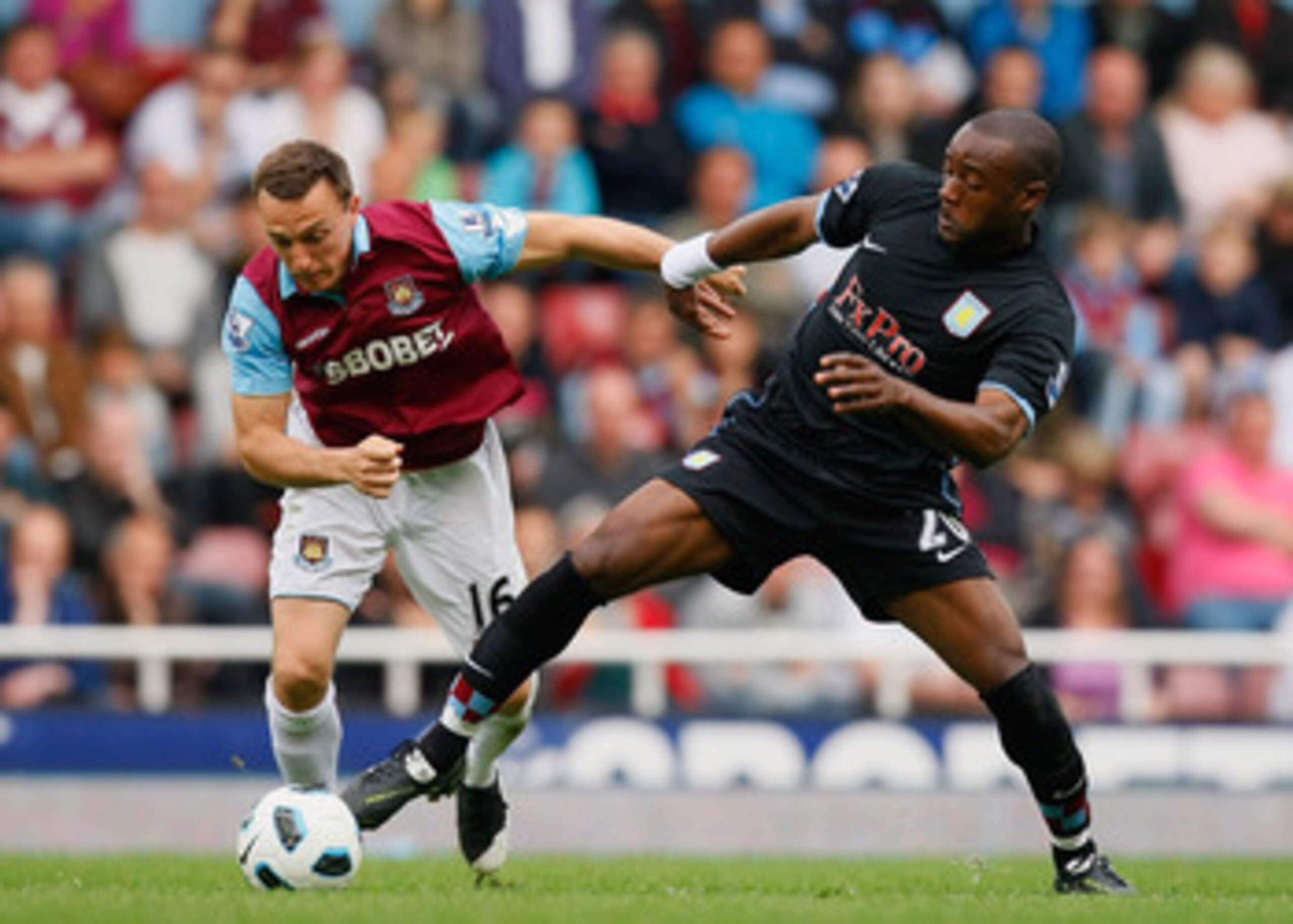 LONDON, ENGLAND - APRIL 16: Mark Noble of West Ham United and Nigel Reo-Coker of Aston Villa battle for the ball during the Barclays Premier League match between West Ham United and Aston Villa at the Boleyn Ground on April 16, 2011 in London, England. LONDON, ENGLAND - APRIL 16: Mark Noble of West Ham United and Nigel Reo-Coker of Aston Villa battle for the ball during the Barclays Premier League match between West Ham United and Aston Villa at the Boleyn Ground on April 16, 2011 in London, England.