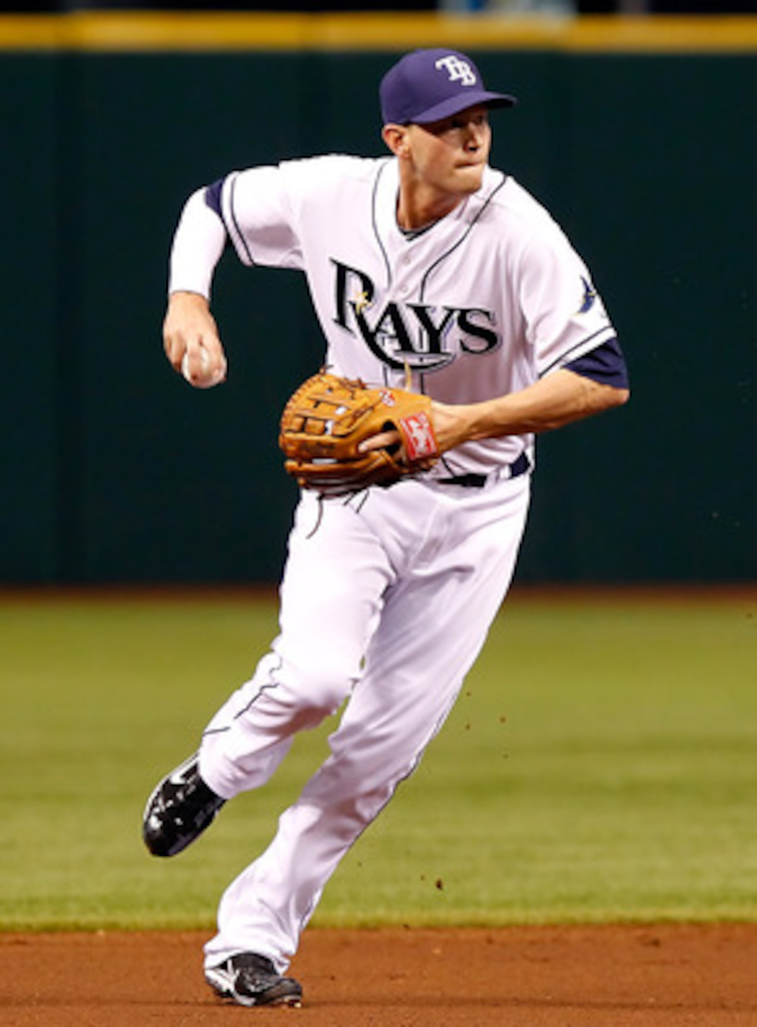 ST. PETERSBURG, FL - APRIL 15:  Infielder Reid Brignac #15 of the Tampa Bay Rays throws over to first for an out against the Minnesota Twins during the game at Tropicana Field on April 15, 2011 in St. Petersburg, Florida.  (Photo by J. Meric/Getty Images)