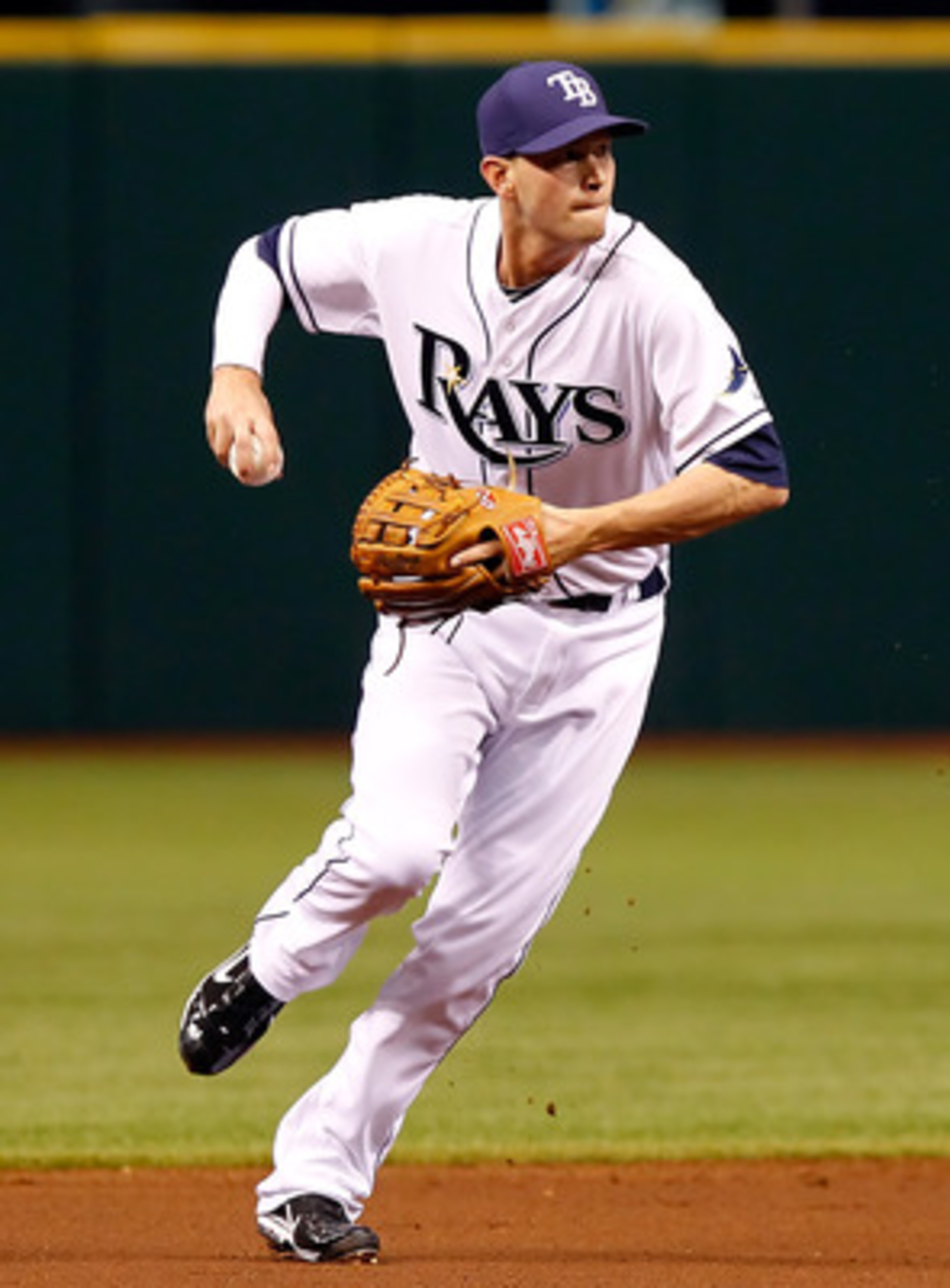 ST. PETERSBURG, FL - APRIL 15:  Infielder Reid Brignac #15 of the Tampa Bay Rays throws over to first for an out against the Minnesota Twins during the game at Tropicana Field on April 15, 2011 in St. Petersburg, Florida.  (Photo by J. Meric/Getty Images)