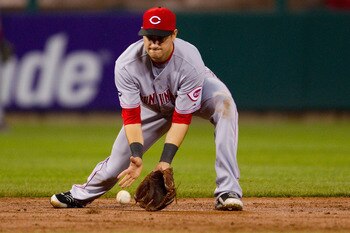 ST. LOUIS, MO - APRIL 23: Paul Janish #7 of the Cincinnati Reds fields a groundball against the St. Louis Cardinals at Busch Stadium on April 23, 2011 in St. Louis, Missouri.  (Photo by Dilip Vishwanat/Getty Images)