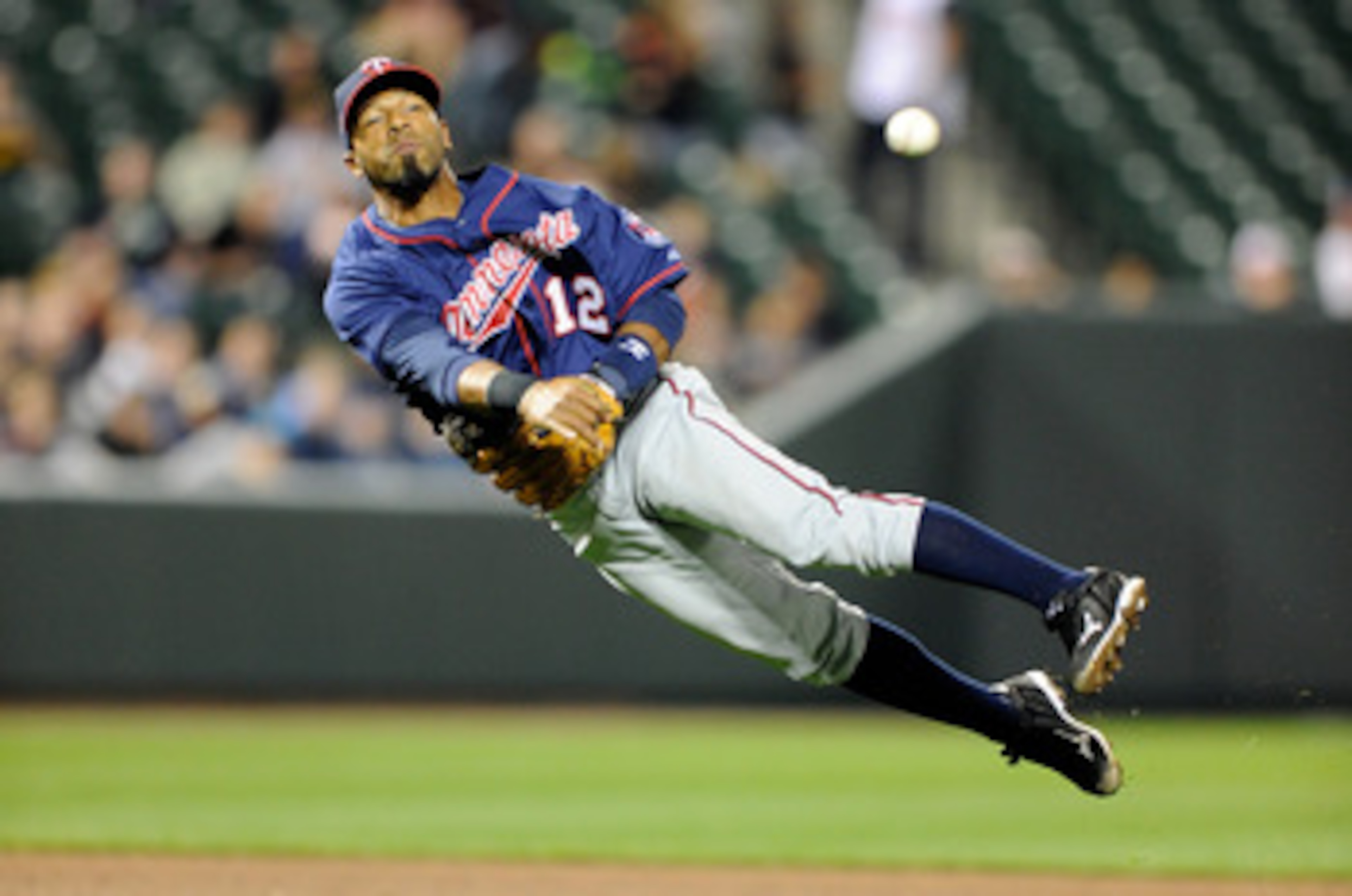 BALTIMORE, MD - APRIL 18:  Alexi Casilla #12 of the Minnesota Twins throws the ball to first base against the Baltimore Orioles at Oriole Park at Camden Yards on April 18, 2011 in Baltimore, Maryland.  (Photo by Greg Fiume/Getty Images)