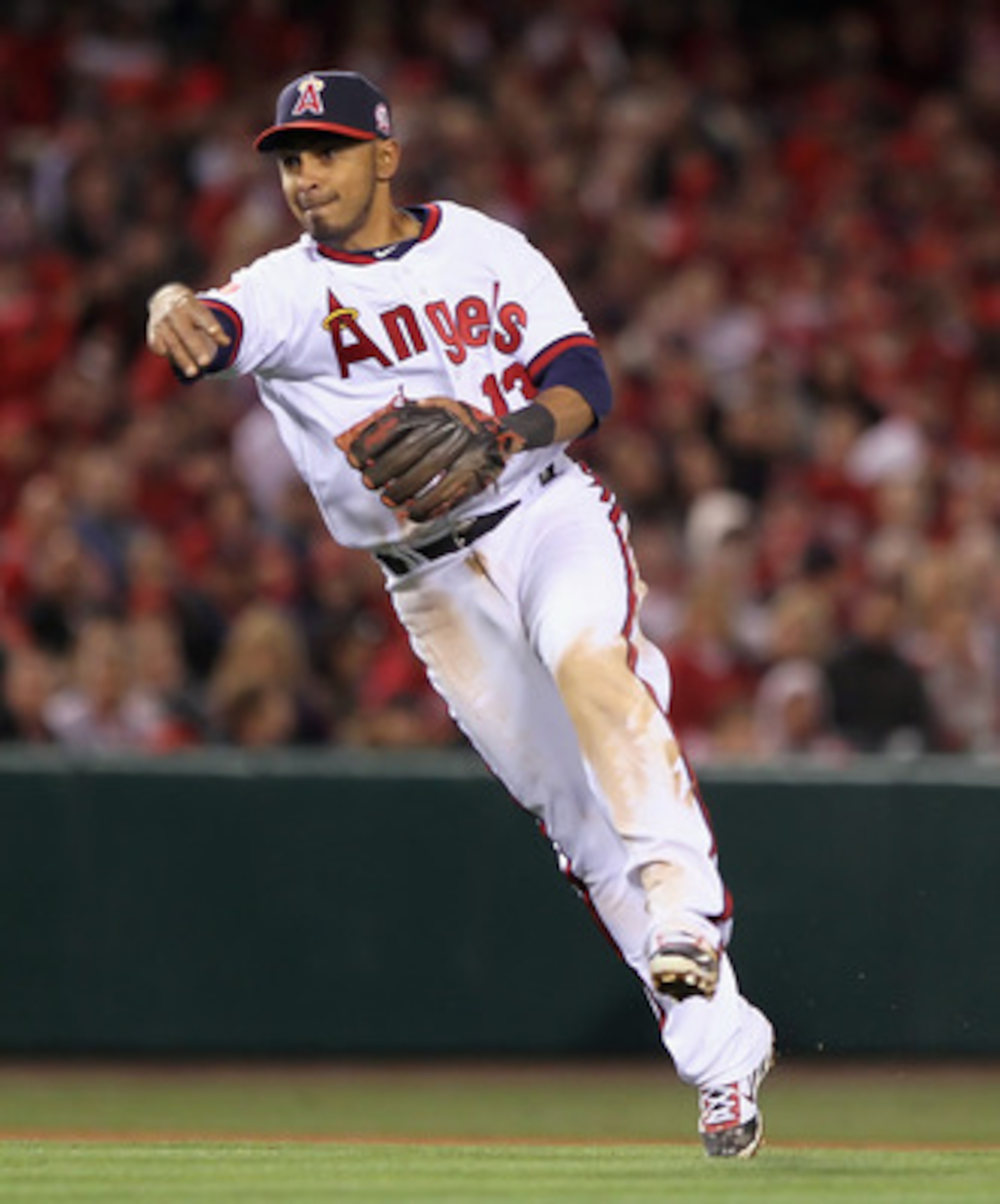 ANAHEIM, CA - APRIL 08:  Maicer Izturis #13 of the Los Angeles Angels of Anaheim fields a ground ball and throws to first base in the fifth inning against the Toronto Blue Jays at Angel Stadium of Anaheim on April 8, 2011 in Anaheim, California. The Blue 