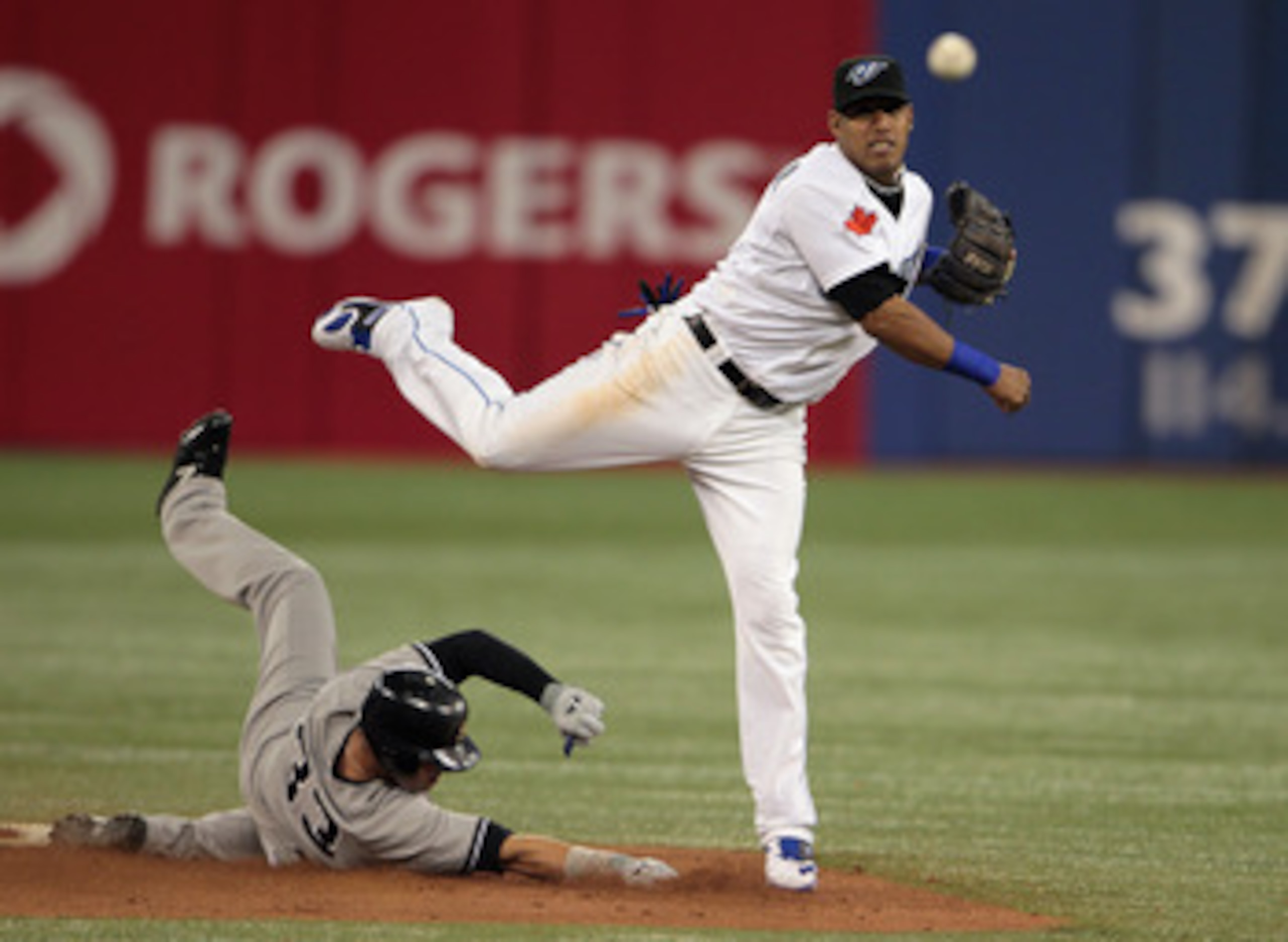 TORONTO, ON - APRIL 19:  Yunel Escobar #5 of the Toronto Blue Jays makes a play to get Nick Swisher #33 of the New York Yankees out at second base during their game at Rogers Centre on April 19, 2011 in Toronto, Canada.  (Photo by Scott Halleran/Getty Ima