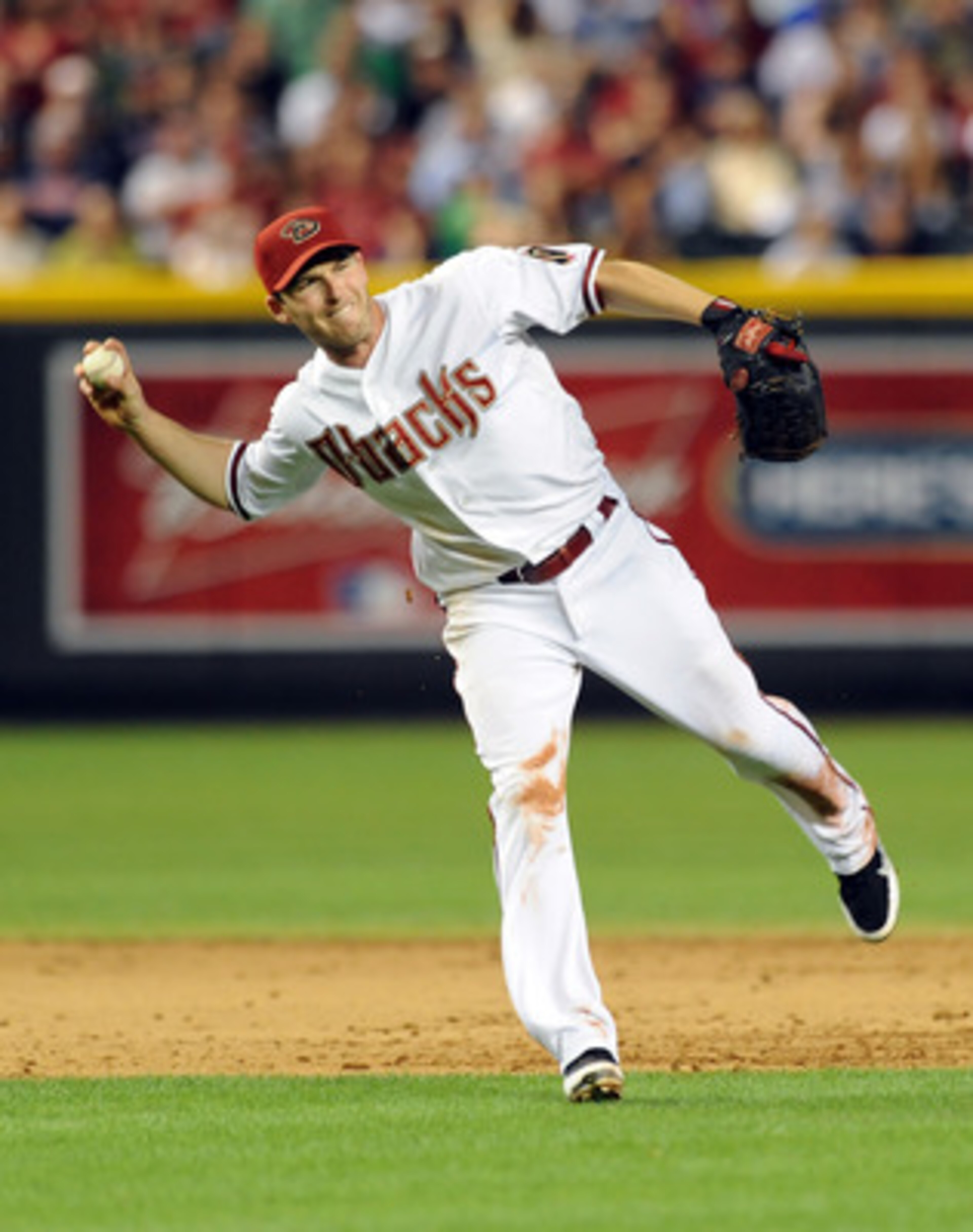 PHOENIX - MAY 20:  Stephen Drew #6 of the Arizona Diamondbacks makes a barehanded play against the Minnesota Twins at Chase Field on May 20, 2011 in Phoenix, Arizona.  (Photo by Norm Hall/Getty Images)