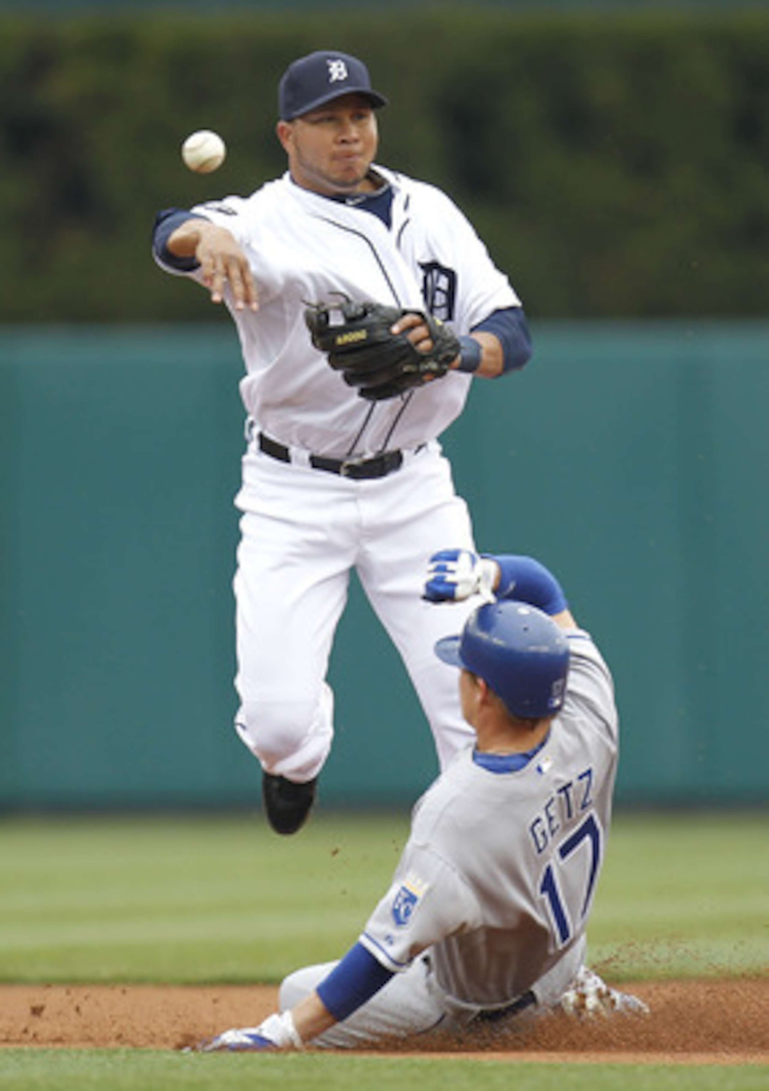 DETROIT, MI - APRIL 08:  Jhonny Peralta #27 of the Detroit Tigers turns a double play over Chris Getz #17 of the Kansas City Royals during Opening Day at Comerica Park on April 8, 2011 in Detroit, Michigan.  (Photo by Gregory Shamus/Getty Images)