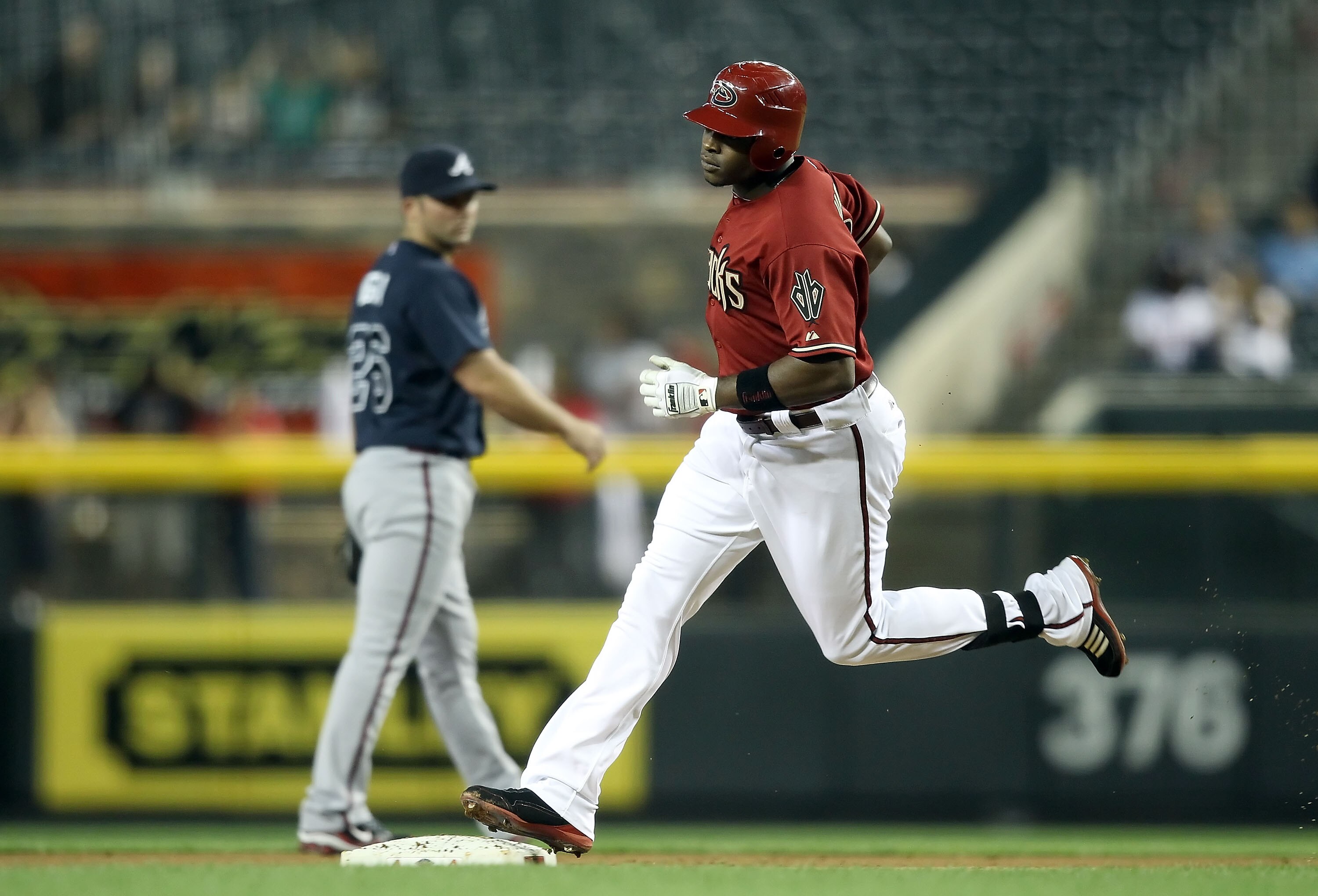 PHOENIX, AZ - MAY 18: Justin Upton #10 of the Arizona Diamondbacks rounds the bases after hitting a solo home run during the first inning of the Major League Baseball game against the Atlanta Braves at Chase Field on May 18, 2011 in Phoenix, Arizona. (P PHOENIX, AZ - MAY 18: Justin Upton #10 of the Arizona Diamondbacks rounds the bases after hitting a solo home run during the first inning of the Major League Baseball game against the Atlanta Braves at Chase Field on May 18, 2011 in Phoenix, Arizona. (P