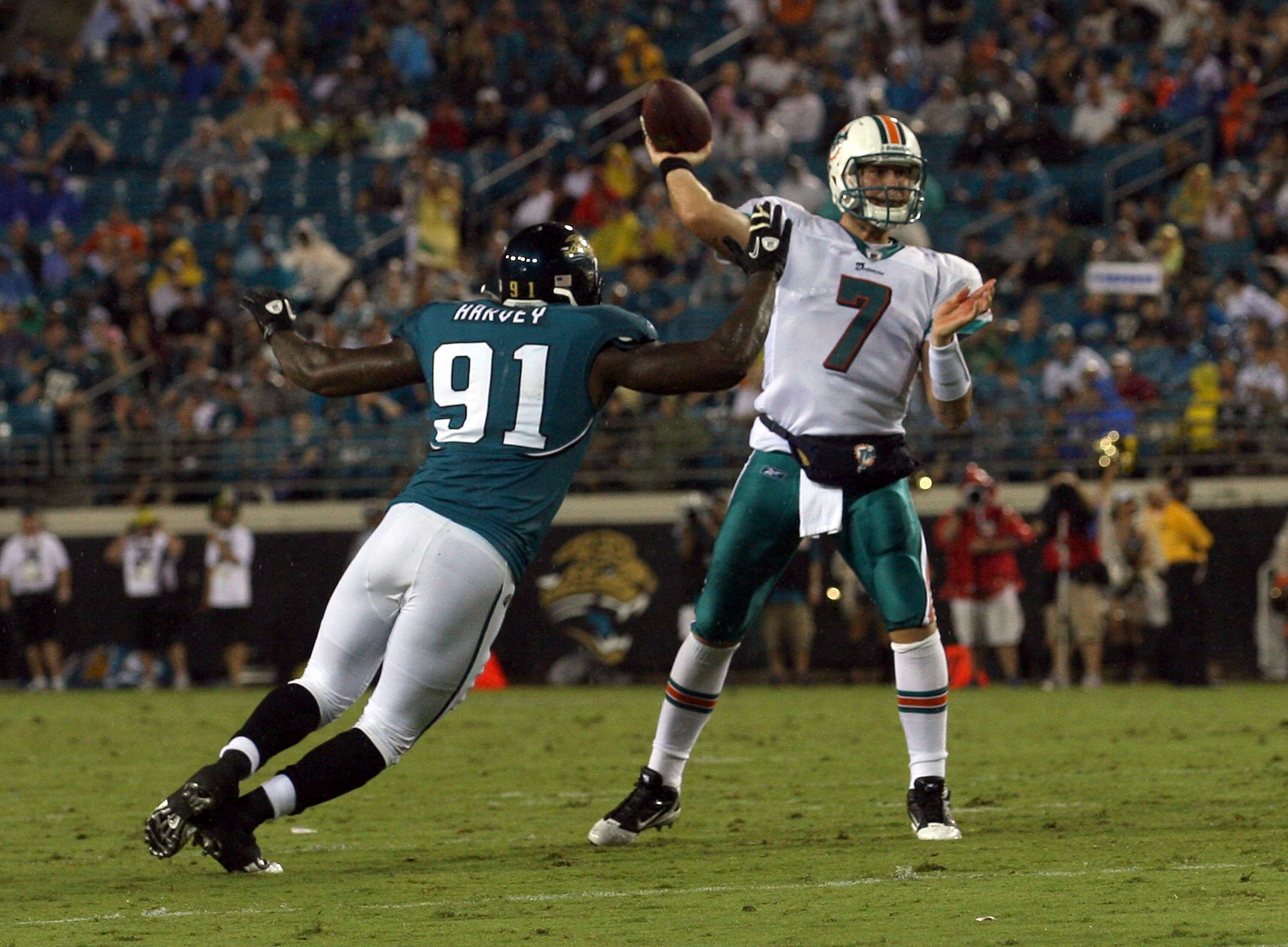 JACKSONVILLE, FL - AUGUST 21:  Derrick Harvey #91 of the Jacksonville Jaguars attempts to tackle Chad Henne #7 of the Miami Dolphins during the preseason game at EverBank Field on August 21, 2010 in Jacksonville, Florida.  (Photo by Sam Greenwood/Getty Im