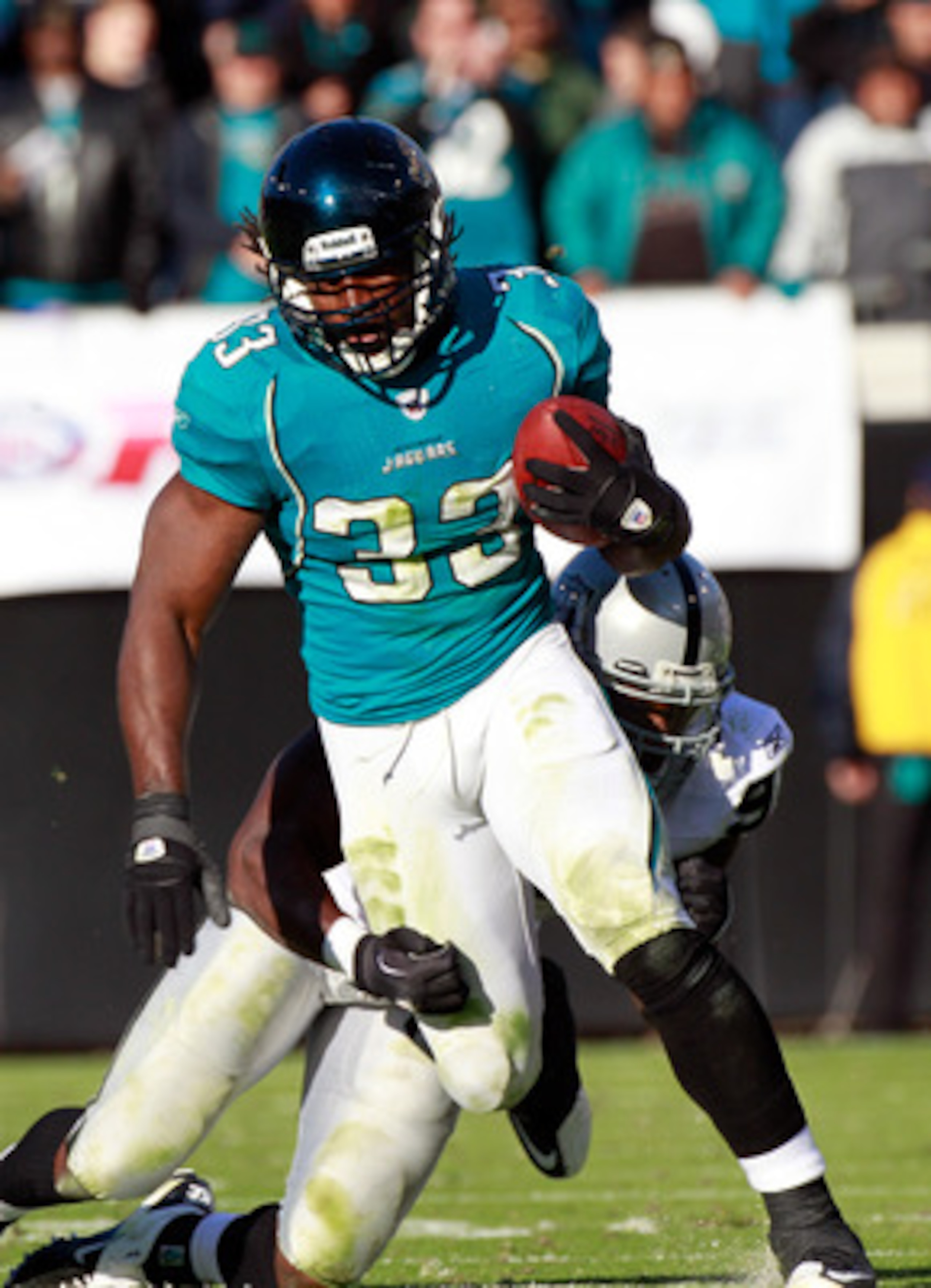 JACKSONVILLE, FL - DECEMBER 12:  Greg Jones #33 of the Jacksonvile Jaguars breaks the tackle of Kamerion Wimbley #96 of the Oaklnad Raiders during the game at EverBank Field on December 12, 2010 in Jacksonville, Florida.  (Photo by Sam Greenwood/Getty Ima