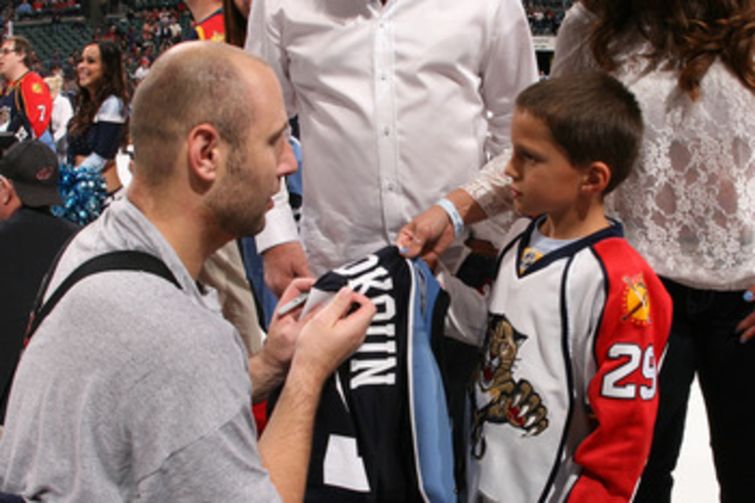 SUNRISE, FL - APRIL 9: Goaltender Tomas Vokoun #29 of the Florida Panthers signs his jersey for a young fan after it was won on auction after the game against the Washington Capitals on April 9, 2011 at the BankAtlantic Center in Sunrise, Florida. The Pan