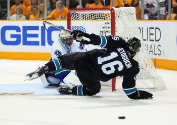 SAN JOSE, CA - MAY 20: Devin Setoguchi #16 of the San Jose Sharks falls over goaltender Roberto Luongo #1 of the Vancouver Canucks in the first period in Game Three of the Western Conference Finals during the 2011 Stanley Cup Playoffs at HP Pavilion on Ma
