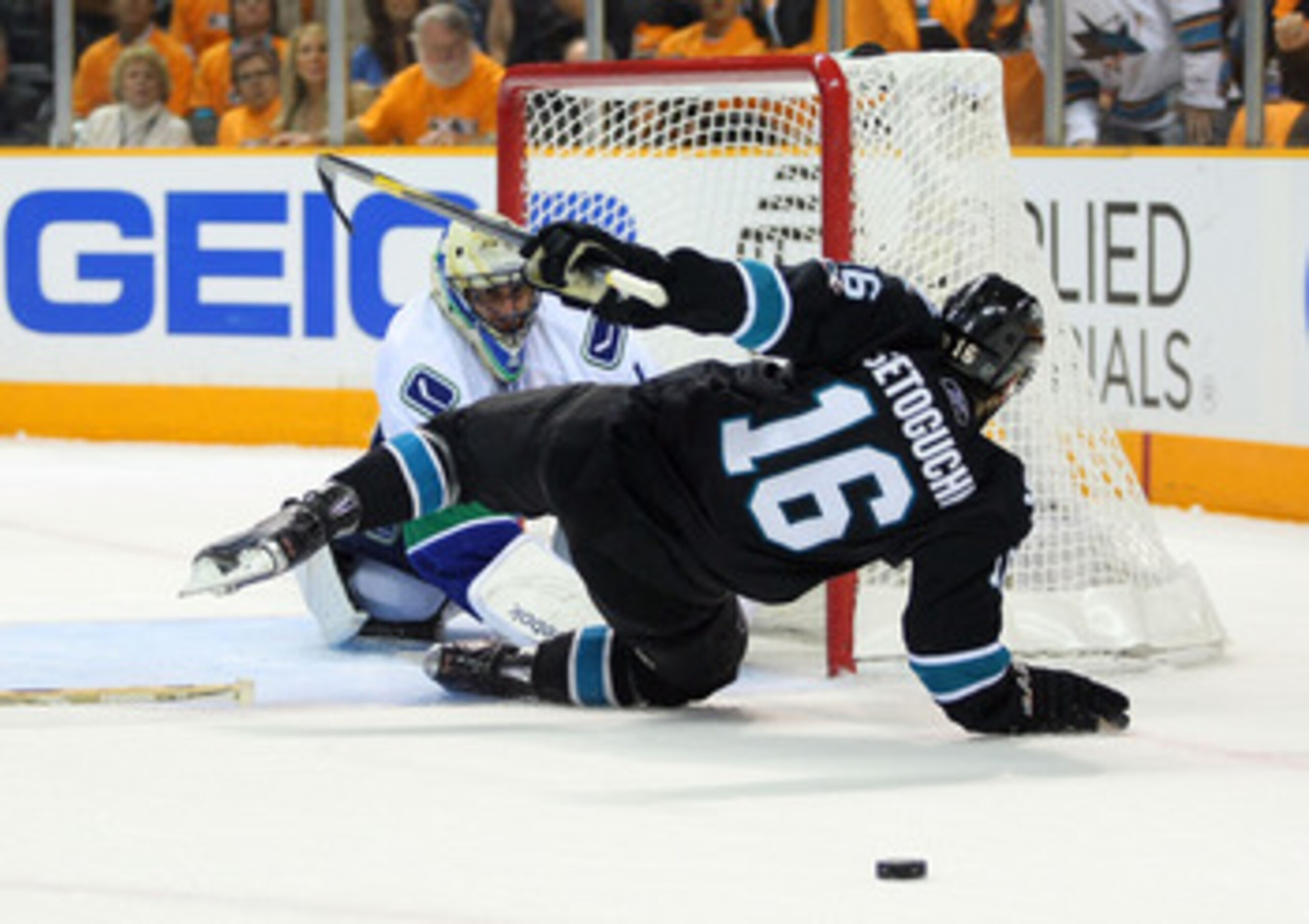 SAN JOSE, CA - MAY 20: Devin Setoguchi #16 of the San Jose Sharks falls over goaltender Roberto Luongo #1 of the Vancouver Canucks in the first period in Game Three of the Western Conference Finals during the 2011 Stanley Cup Playoffs at HP Pavilion on Ma