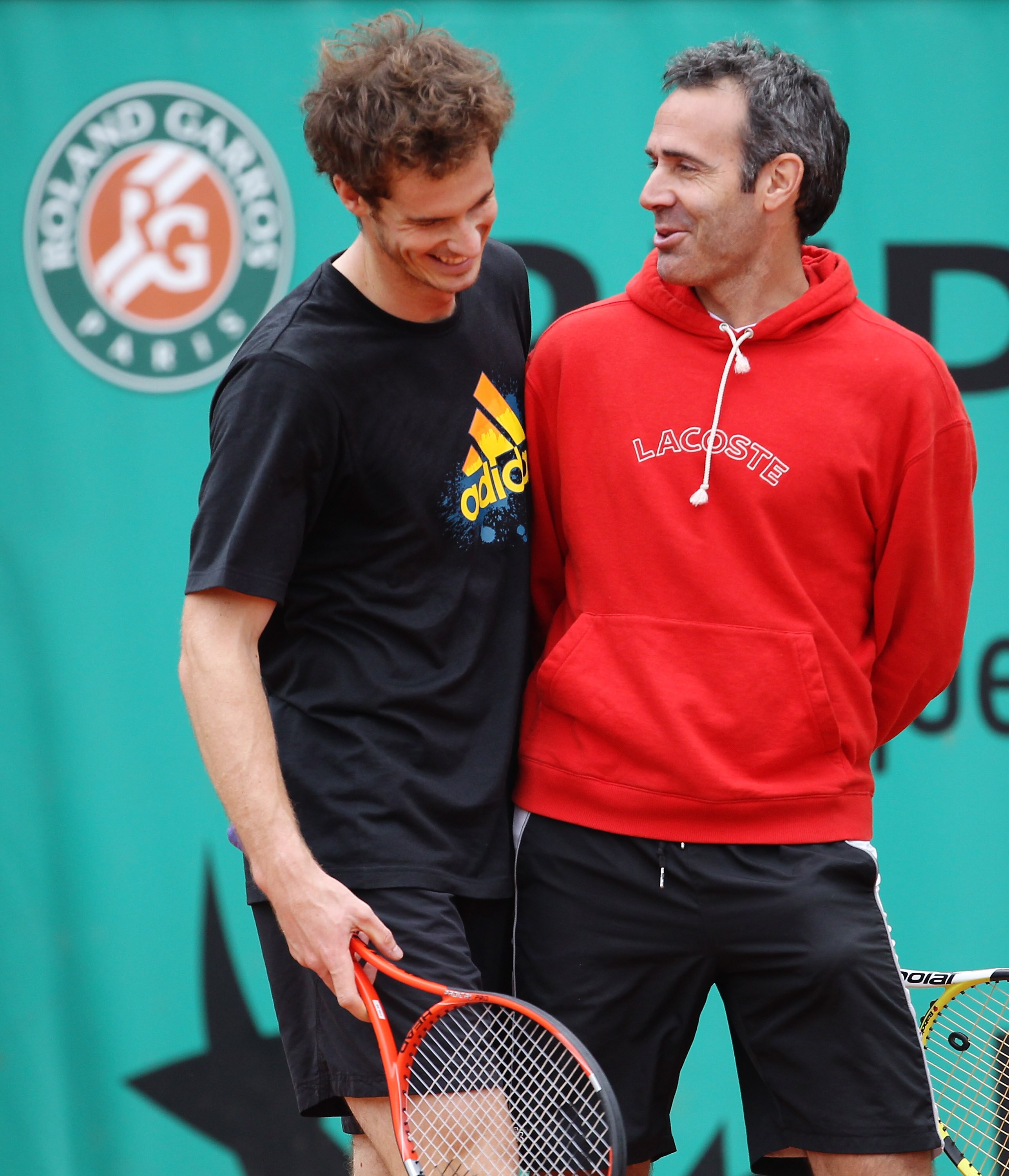 PARIS - MAY 29:  Andy Murray of Great Britain shares a joke with his coach Alex Corretja during a practice session on day seven of the French Open at Roland Garros on May 29, 2010 in Paris, France.  (Photo by Julian Finney/Getty Images)