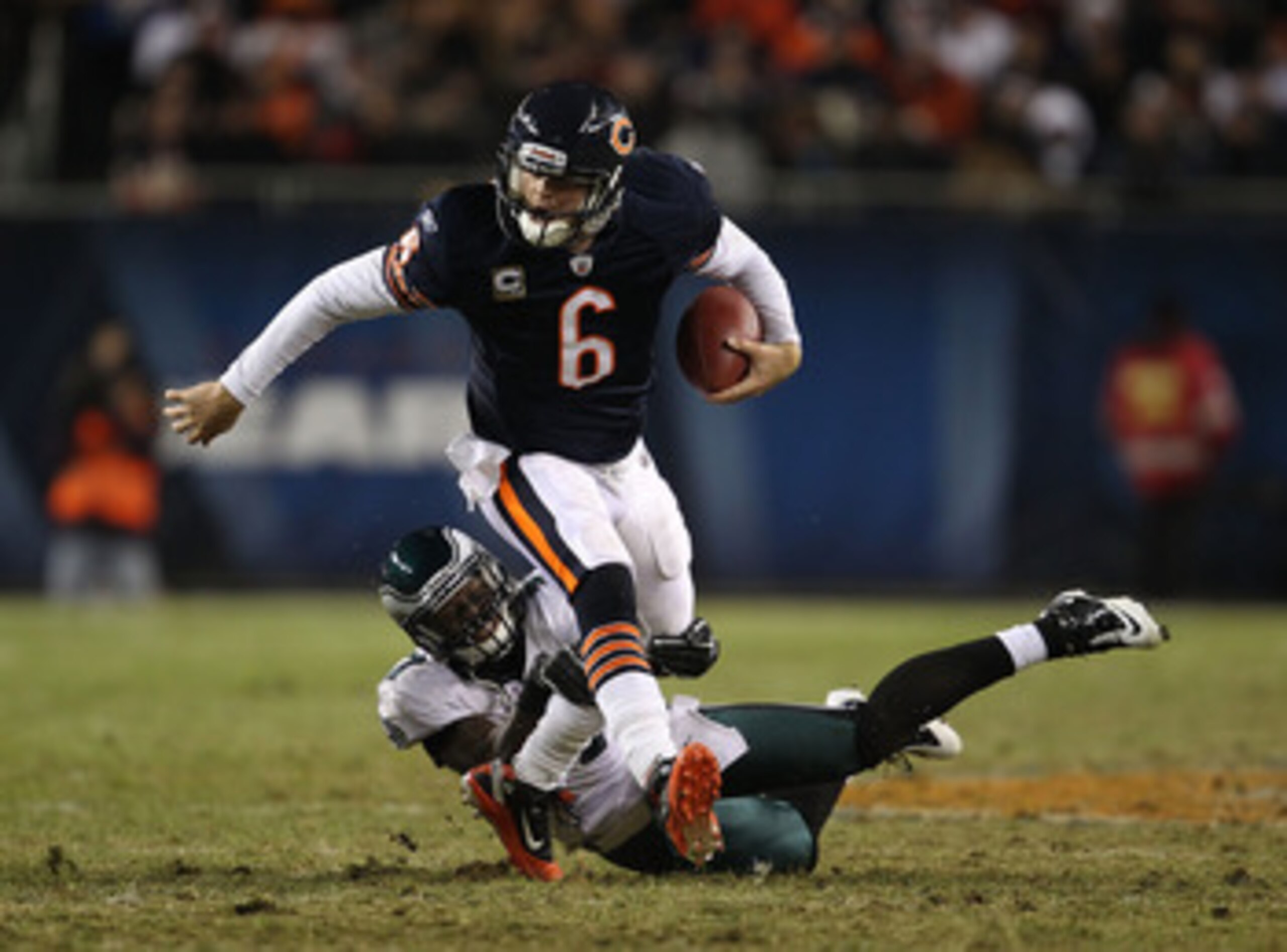 CHICAGO - NOVEMBER 28: Jay Cutler #6 of the Chicago Bears breaks away from Quintin Mikell #27 of the Philadelphia Eagles at Soldier Field on November 28, 2010 in Chicago, Illinois. The Bears defeated the Eagles 31-26. (Photo by Jonathan Daniel/Getty Image