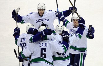 SAN JOSE, CA - MAY 22:  (L-R) Ryan Kesler #17, Daniel Sedin #22, Sami Salo #6, Henrik Sedin #33 and Alex Burrows #14 of the Vancouver Canucks celebrate Salo's second goal of the second period in Game Four of the Western Conference Finals against the San J