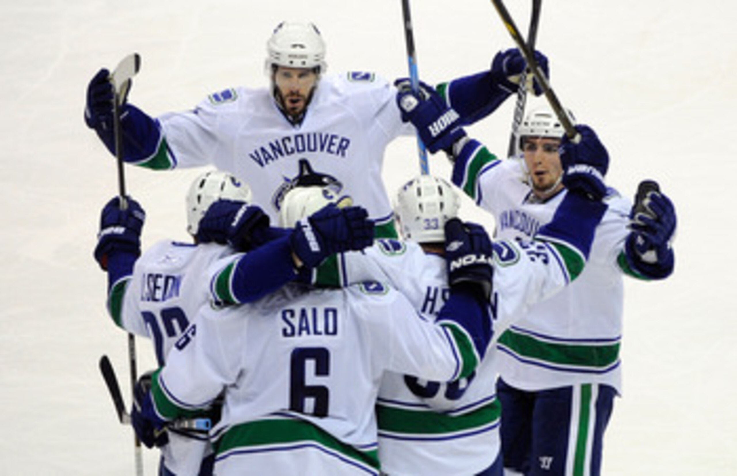SAN JOSE, CA - MAY 22:  (L-R) Ryan Kesler #17, Daniel Sedin #22, Sami Salo #6, Henrik Sedin #33 and Alex Burrows #14 of the Vancouver Canucks celebrate Salo's second goal of the second period in Game Four of the Western Conference Finals against the San J