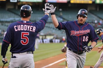 OAKLAND, CA - MAY 18:  Jason Kubel #16 is congratulated by Michael Cuddyer #5 of the Minnesota Twins after he scored in the first inning against the Oakland Athletics at Oakland-Alameda County Coliseum on May 18, 2011 in Oakland, California.  (Photo by Ez