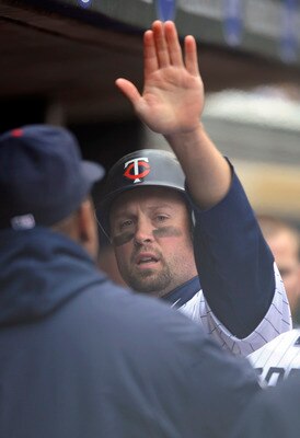 MINNEAPOLIS, MN - APRIL 28: Michael Cuddyer #5 of the Minnesota Twins celebrates scoring with his teammates during in the seventh inning of their game against the Tampa Bay Rays on April 28, 2011 at Target Field in Minneapolis, Minnesota. (Photo by Hannah