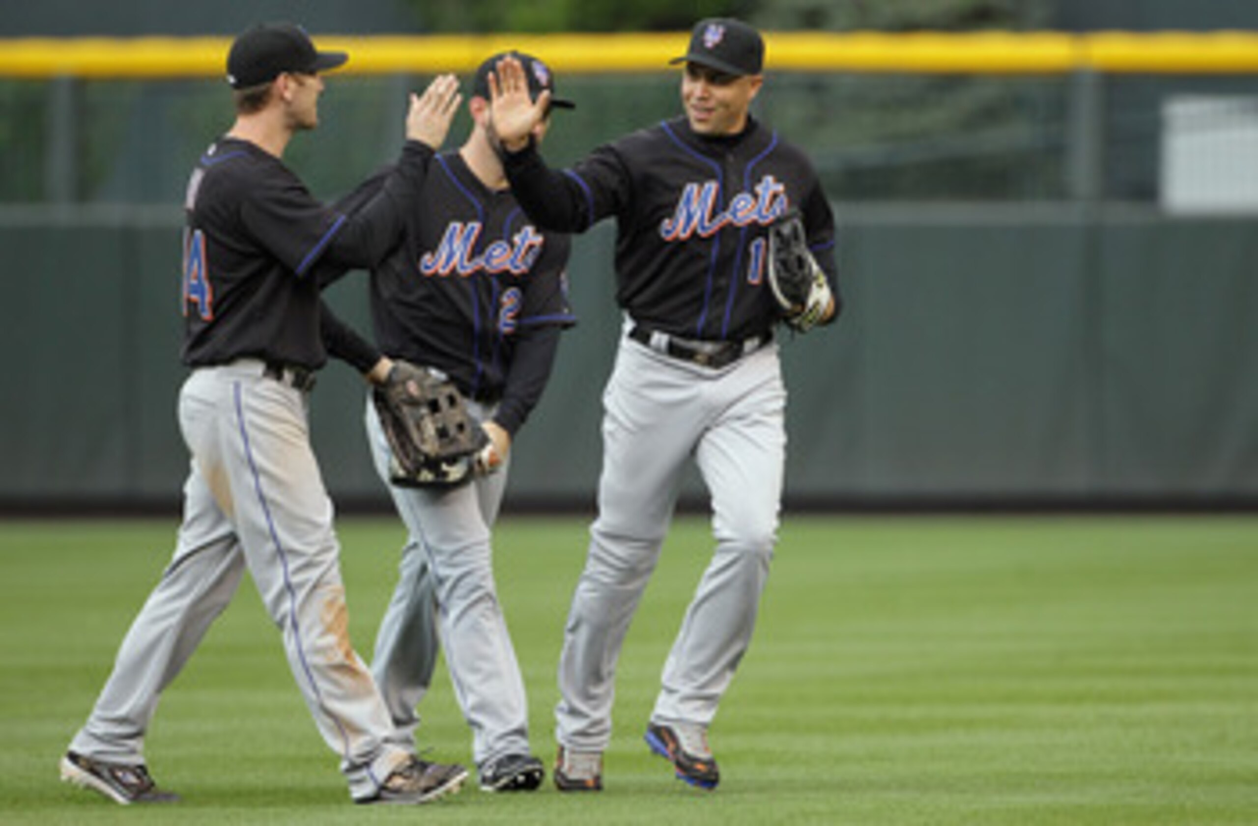 DENVER, CO - MAY 12:  Outfielders Jason Bay #44, Jason Pridie #20 and Carlos Beltran #15 of the New York Mets celebrate their 9-5 victory over the Colorado Rockies at Coors Field on May 12, 2011 in Denver, Colorado.  (Photo by Doug Pensinger/Getty Images)