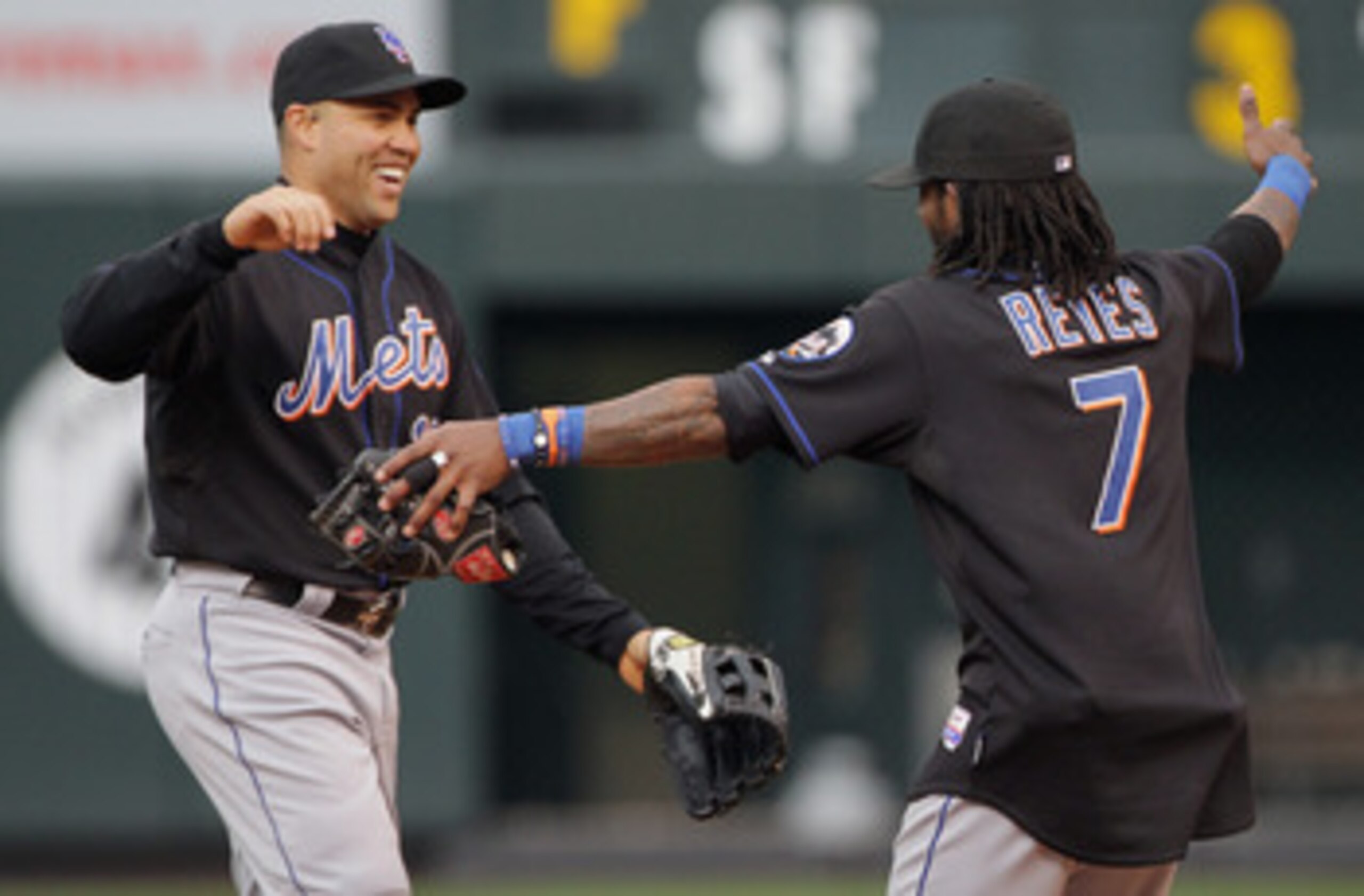 DENVER, CO - MAY 12:  Carlos Beltran #15 and Jose Reyes #7 of the New York Mets celebrate their 9-5 victory over the Colorado Rockies at Coors Field on May 12, 2011 in Denver, Colorado.  (Photo by Doug Pensinger/Getty Images)