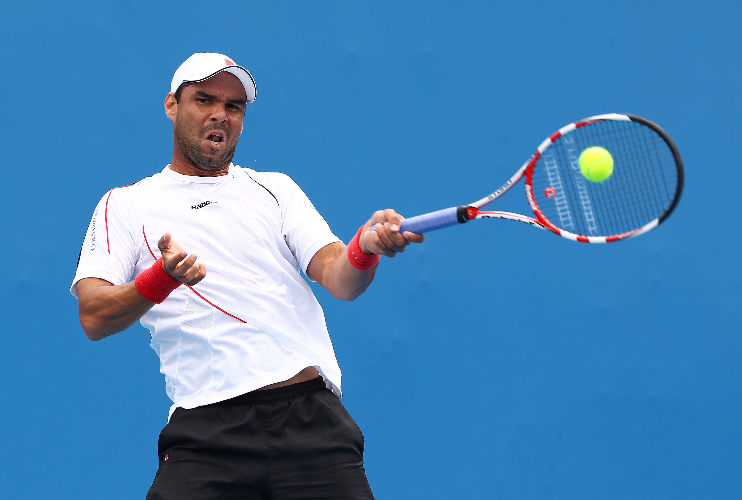MELBOURNE, AUSTRALIA - JANUARY 18:  Alejandro Falla of Colombia plays a forehand in his first round match against Feliciano Lopez of Spain during day two of the 2011 Australian Open at Melbourne Park on January 18, 2011 in Melbourne, Australia.  (Photo by