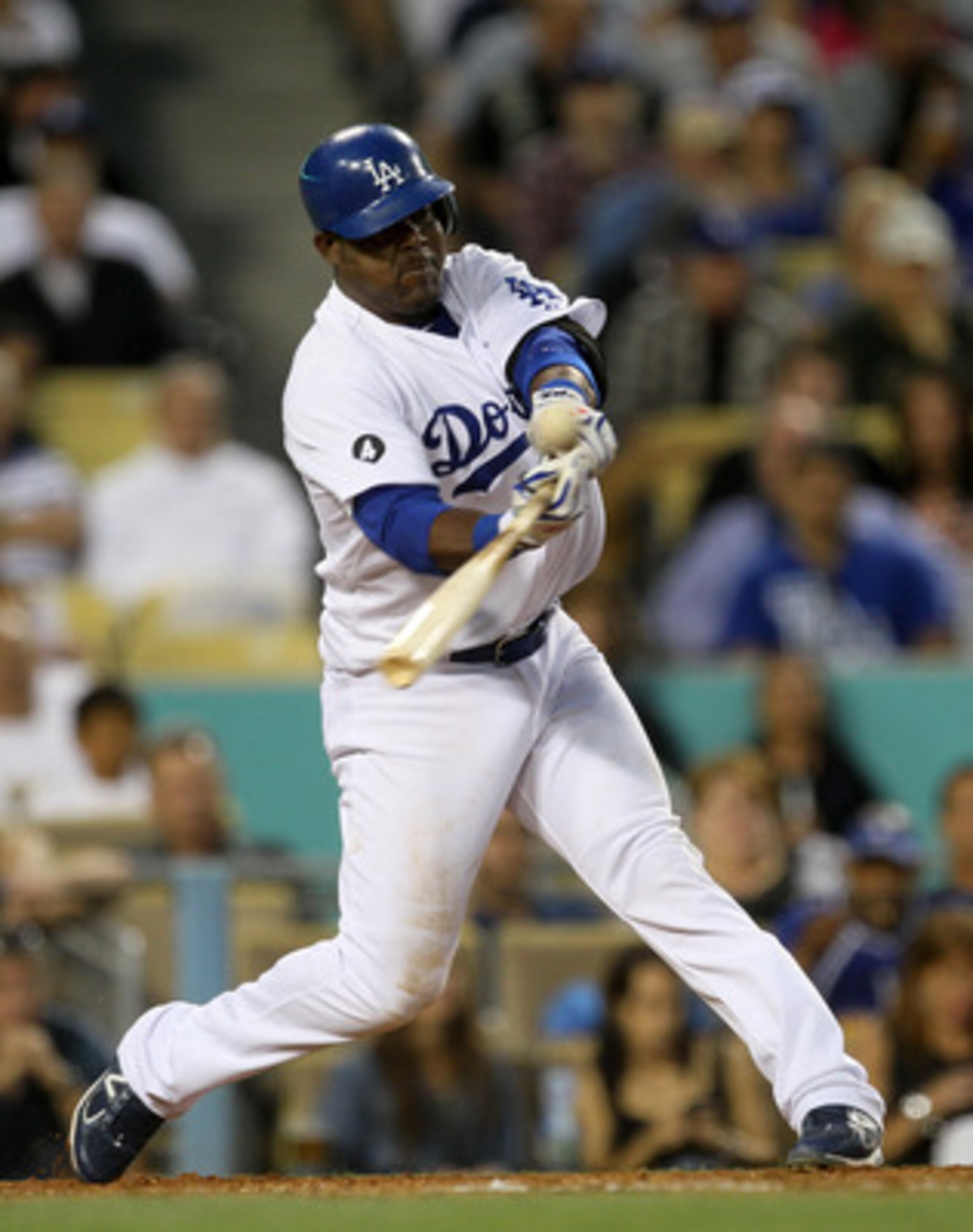 LOS ANGELES - MAY 2:  Juan Uribe #5 of the Los Angeles Dodgers hits an RBI double in the second inning against the Chicago Cubs  on May 2, 2011 at Dodger Stadium in Los Angeles, California.  (Photo by Stephen Dunn/Getty Images)