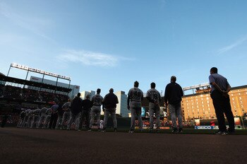 BALTIMORE, MD - MAY 12:  Members of the Seattle Mariners listen to the national anthem before the start of their game against the Baltimore Orioles at Oriole Park at Camden Yards on May 12, 2011 in Baltimore, Maryland.  (Photo by Rob Carr/Getty Images)