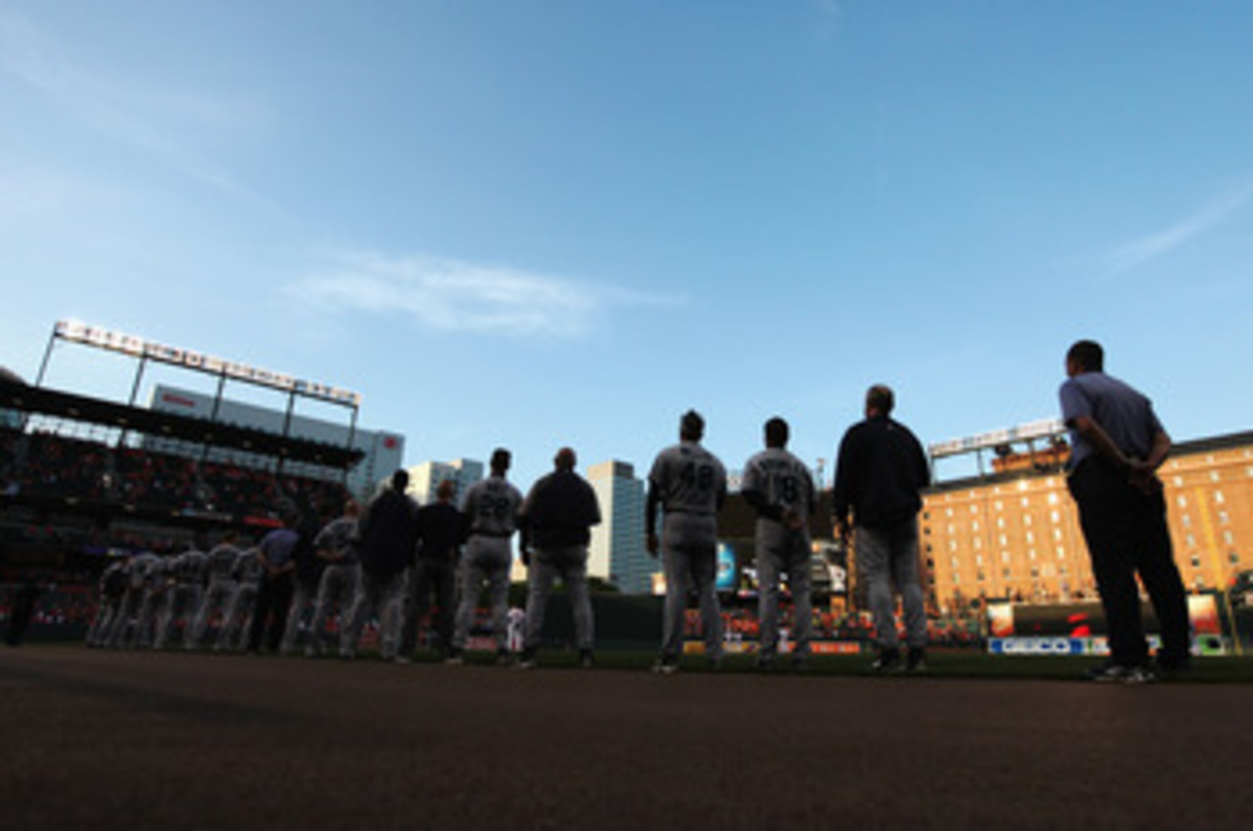 BALTIMORE, MD - MAY 12:  Members of the Seattle Mariners listen to the national anthem before the start of their game against the Baltimore Orioles at Oriole Park at Camden Yards on May 12, 2011 in Baltimore, Maryland.  (Photo by Rob Carr/Getty Images)