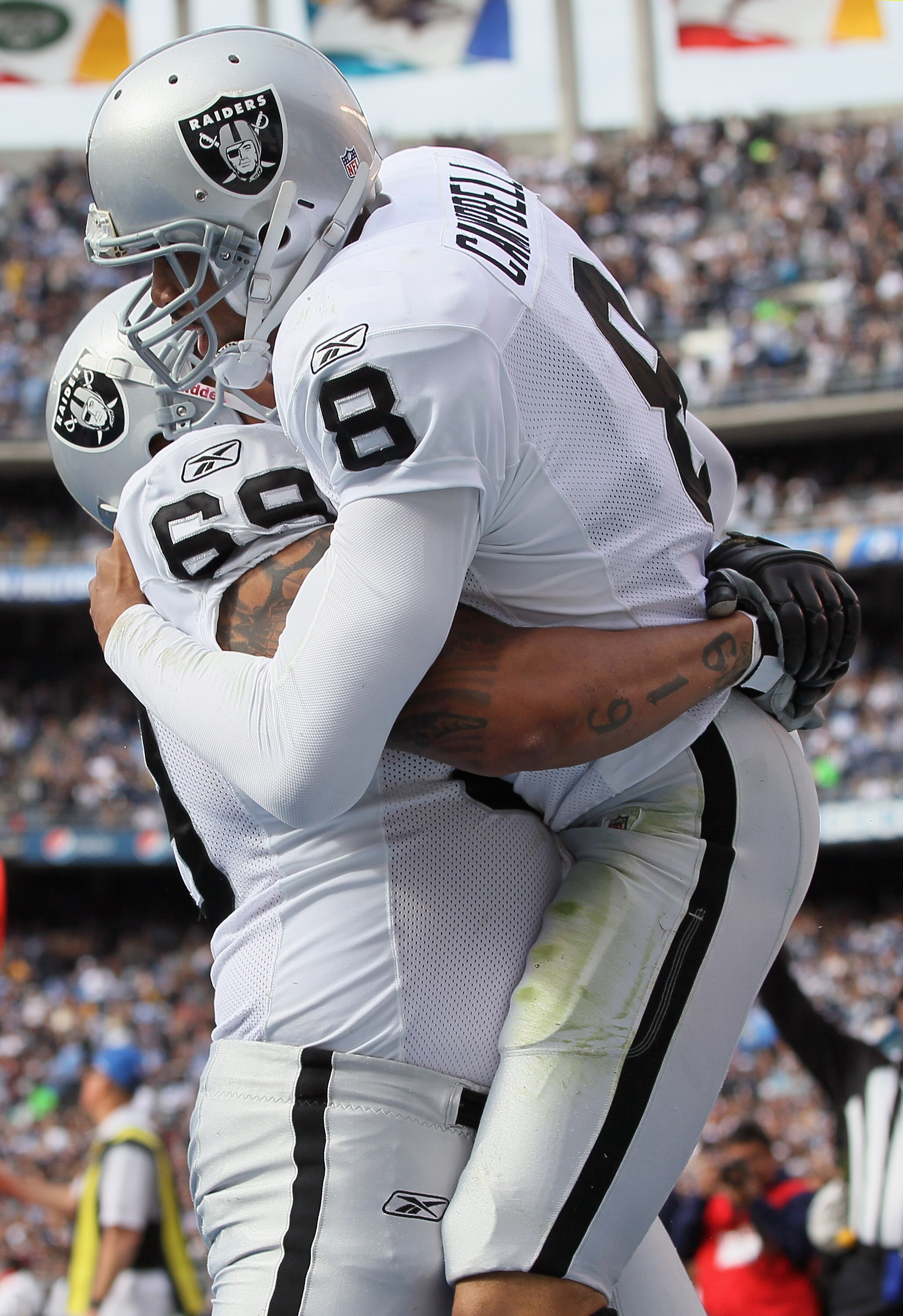 SAN DIEGO - DECEMBER 05:  Quarterback Jason Campbell #8 the Oakland Raiders is congratulated by teammate Khalif Barnes #69 after scoring a touchdown against the San Diego Chargers during the first quarter at Qualcomm Stadium on December 5, 2010 in San Die