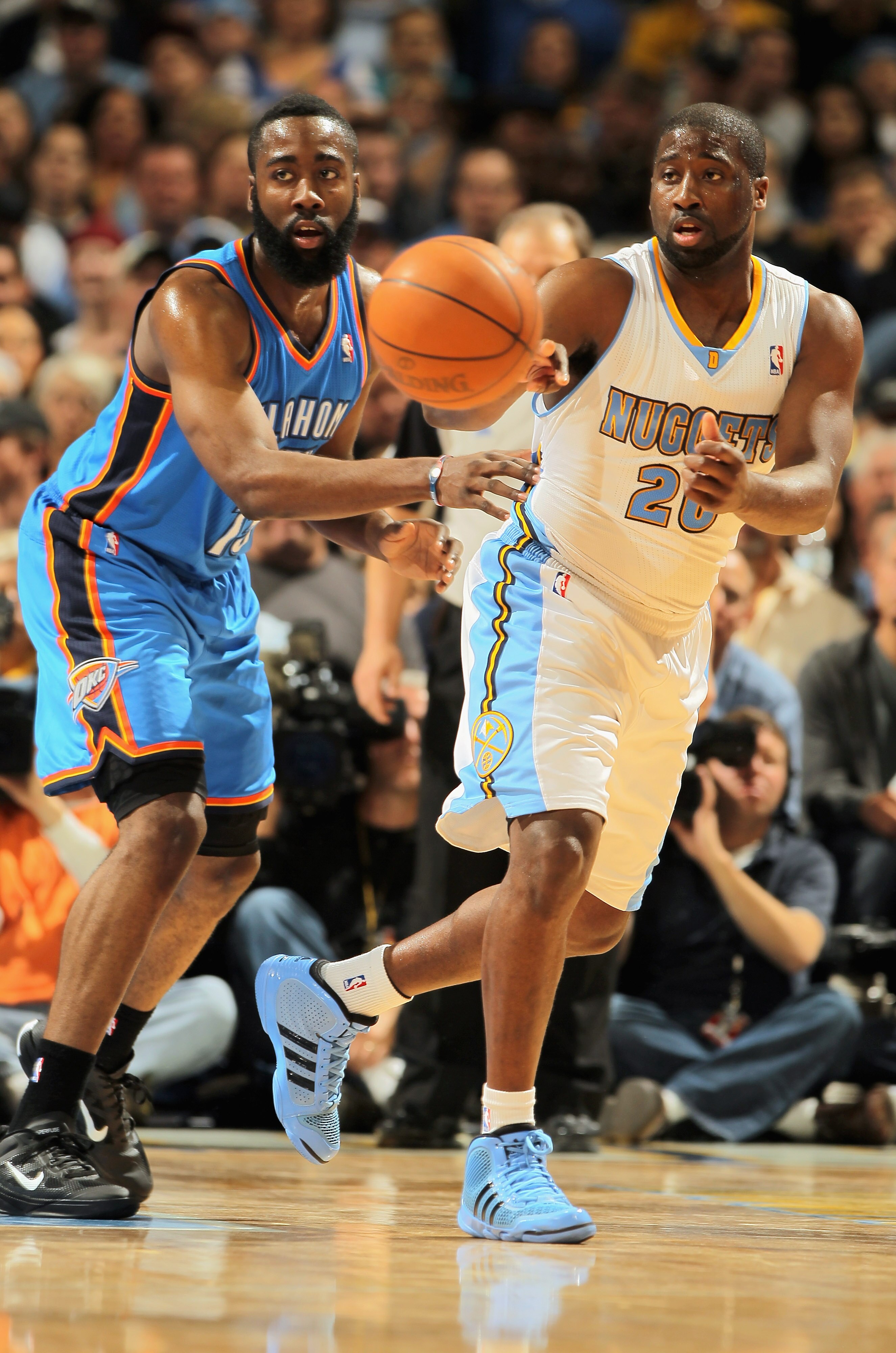 DENVER, CO - APRIL 25:  Raymond Felton #20 of the Denver Nuggets dishes the ball off against James Harden #13 of the Oklahoma City Thunder in Game Four of the Western Conference Quarterfinals in the 2011 NBA Playoffs on April 24, 2011 at the Pepsi Center