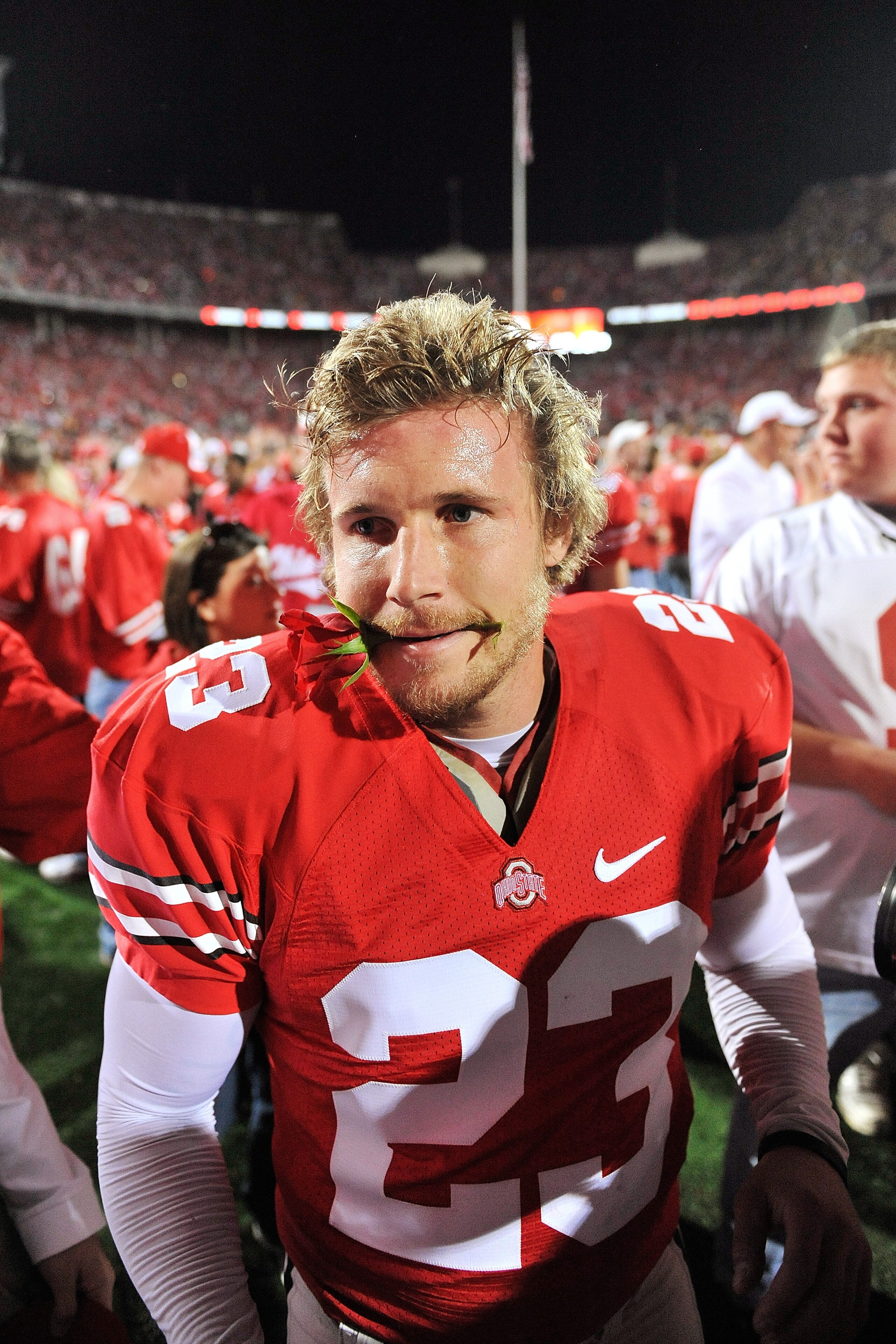 COLUMBUS, OH - NOVEMBER 14:  Kicker Devin Barclay #23 of the Ohio State Buckeyes celebrates the Buckeyes' 27-24 overtime victory over the Iowa Hawkeyes with a rose in his mouth at Ohio Stadium on November 14, 2009 in Columbus, Ohio. Barclay's 39-yard game