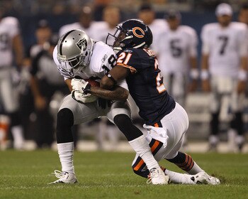 CHICAGO - AUGUST 21: Cory Graham #21 of the Chicago Bears tackles Louis Murphy #18 of the Oakland Raiders during a preseason game at Soldier Field on August 21, 2010 in Chicago, Illinois. The Raiders defeated the Bears 32-17. (Photo by Jonathan Daniel/Get