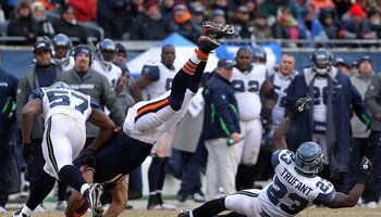 CHICAGO, IL - JANUARY 16:  Kellen Davis #87 of the Chicago Bears flips over after making a catch against David Hawthorne #57 of the Seattle Seahawks in the third quarter of the 2011 NFC divisional playoff game at Soldier Field on January 16, 2011 in Chica