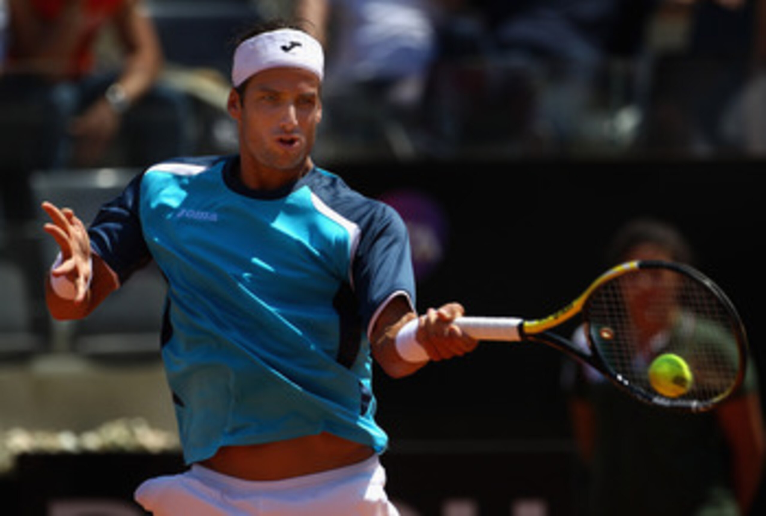 ROME, ITALY - MAY 12:  Feliciano Lopez of Spain hits a forehand return during his third round match against Rafael Nadal of Spain during day five of the Internazionali BNL d'Italia at the Foro Italico Tennis Centre on May 12, 2011 in Rome, Italy.  (Photo 