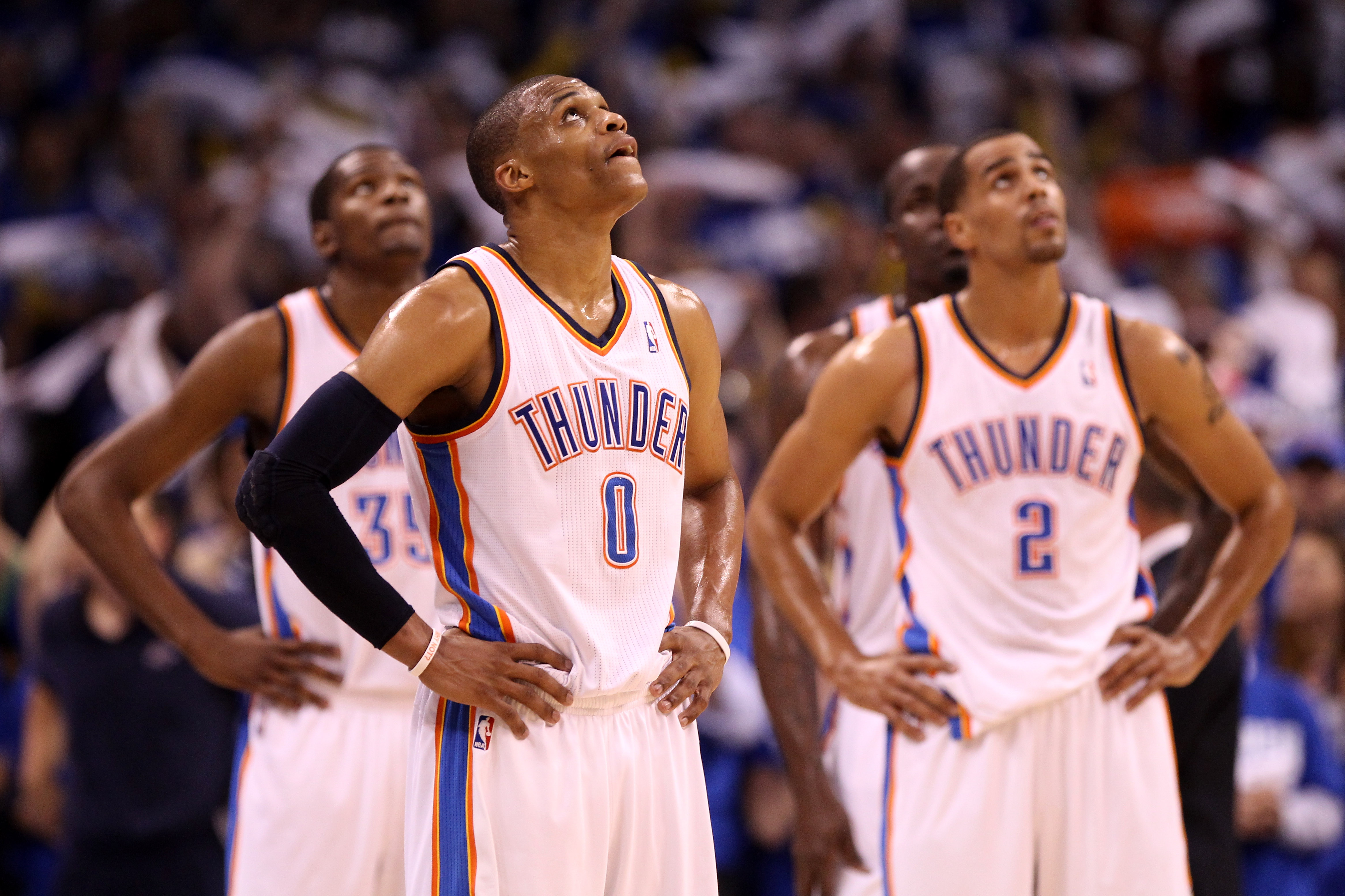 OKLAHOMA CITY, OK - MAY 21:  (C) Russell Westbrook #0 of the Oklahoma City Thunder looks on in the second half while taking on the Dallas Mavericks in Game Three of the Western Conference Finals during the 2011 NBA Playoffs at Oklahoma City Arena on May 2