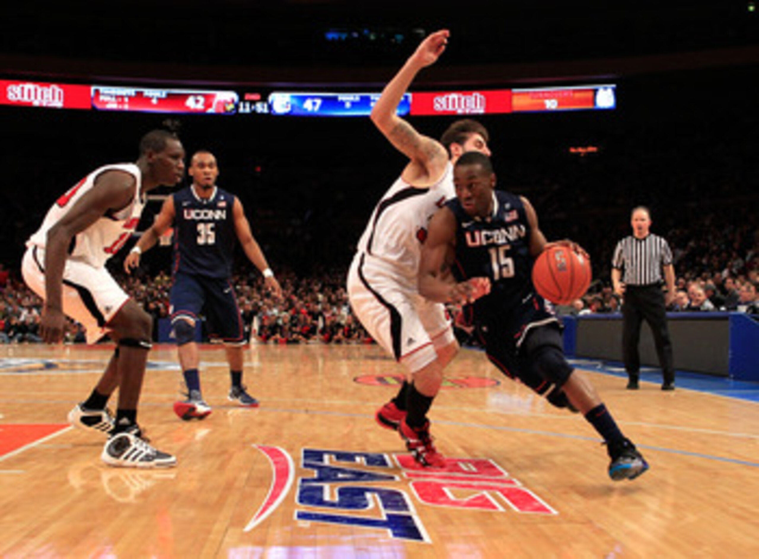 NEW YORK, NY - MARCH 12:  Kemba Walker #15 of the Connecticut Huskies drives with the ball against Mike Marra #33 of the Louisville Cardinals during the championship of the 2011 Big East Men's Basketball Tournament presented by American Eagle Outfitters a