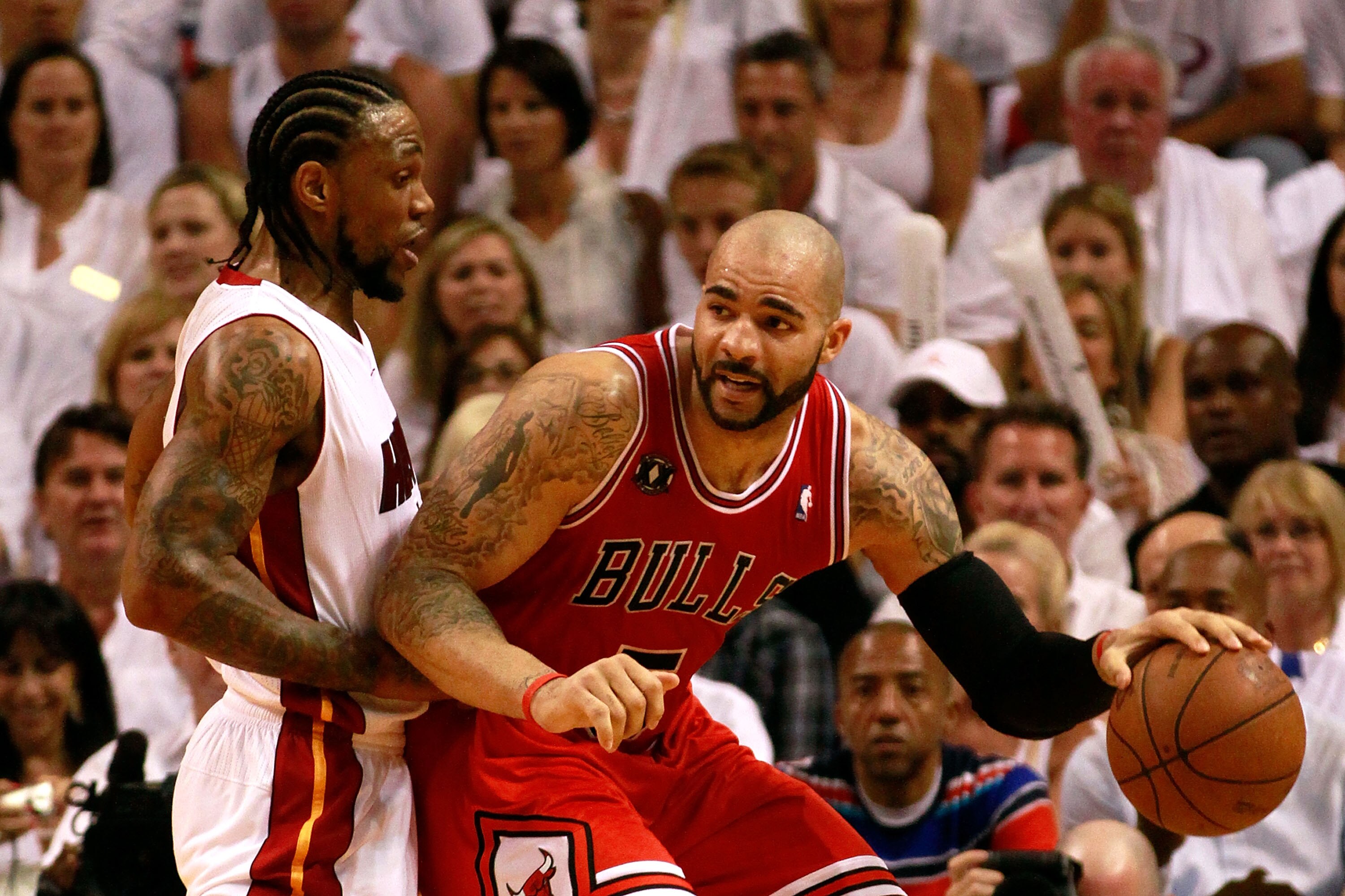 MIAMI, FL - MAY 22:  Carlos Boozer #5 of the Chicago Bulls posts up against Udonis Haslem #40 of the Miami Heat in Game Three of the Eastern Conference Finals during the 2011 NBA Playoffs on May 22, 2011 at American Airlines Arena in Miami, Florida.  NOTE