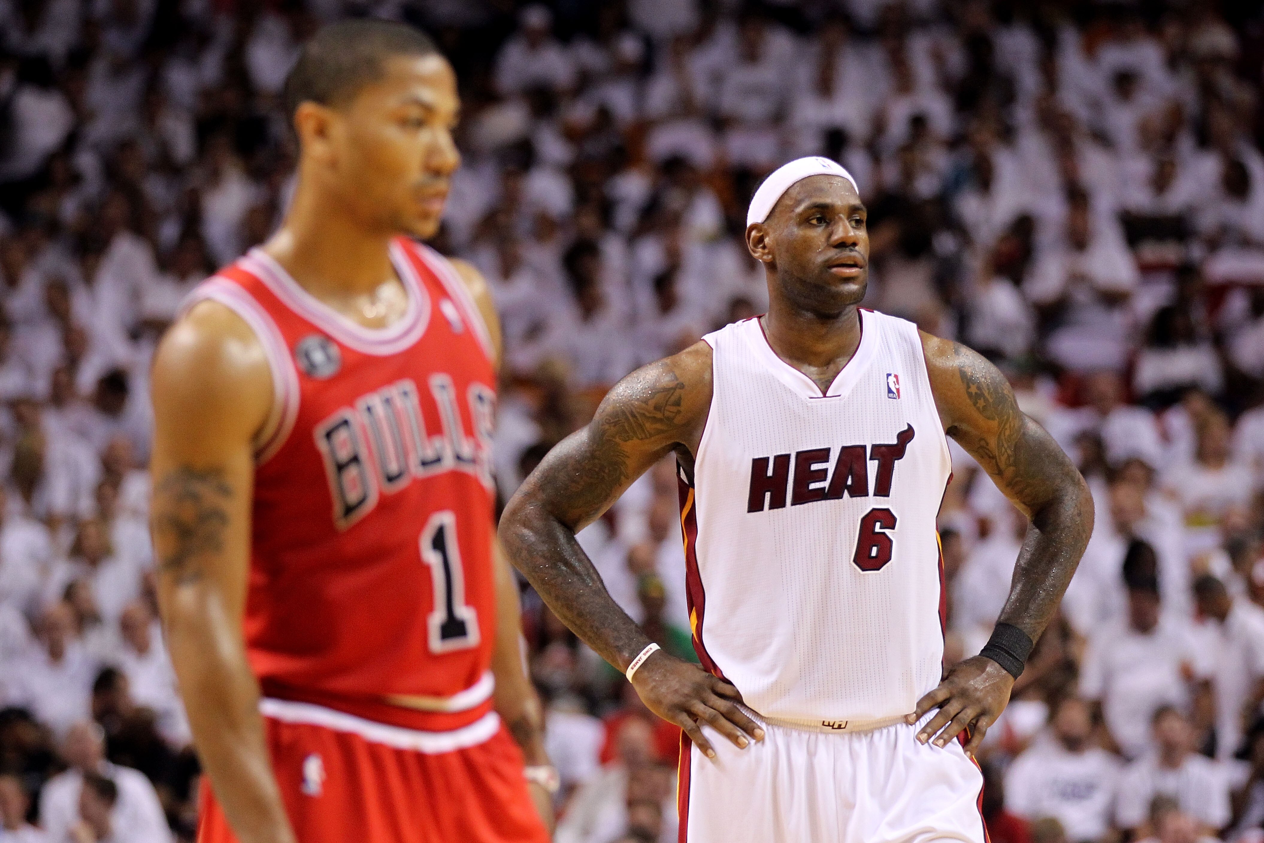 MIAMI, FL - MAY 22:  LeBron James (R) #6 of the Miami Heat looks on as Derrick Rose #1 of the Chicago Bulls stands in the foregrouns in Game Three of the Eastern Conference Finals during the 2011 NBA Playoffs on May 22, 2011 at American Airlines Arena in