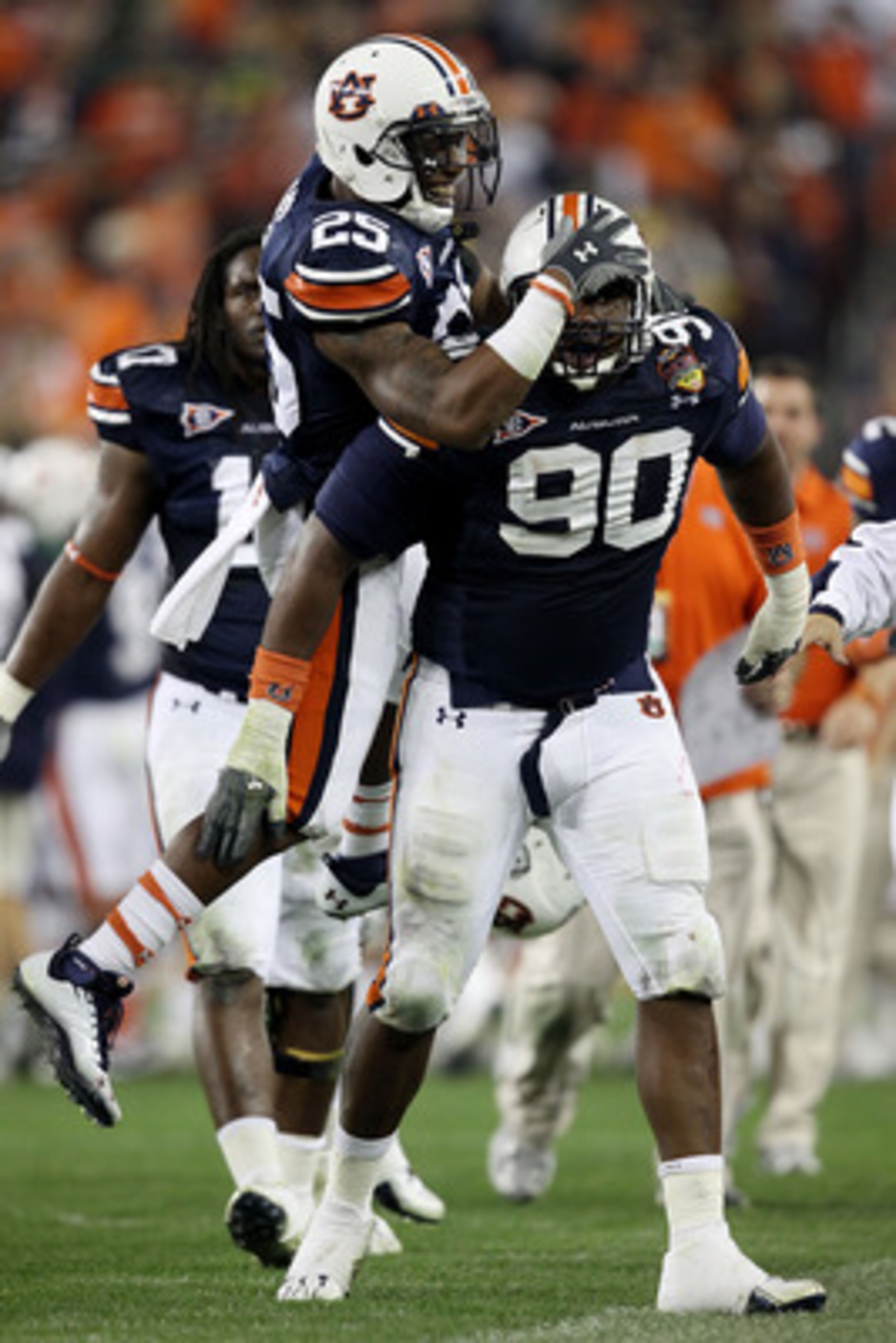 GLENDALE, AZ - JANUARY 10: Nick Fairley #90 of the Auburn Tigers is congratulated by Daren Bates #25 on a sack against the Oregon Ducks during the Tostitos BCS National Championship Game at University of Phoenix Stadium on January 10, 2011 in Glendale, A GLENDALE, AZ - JANUARY 10: Nick Fairley #90 of the Auburn Tigers is congratulated by Daren Bates #25 on a sack against the Oregon Ducks during the Tostitos BCS National Championship Game at University of Phoenix Stadium on January 10, 2011 in Glendale, A