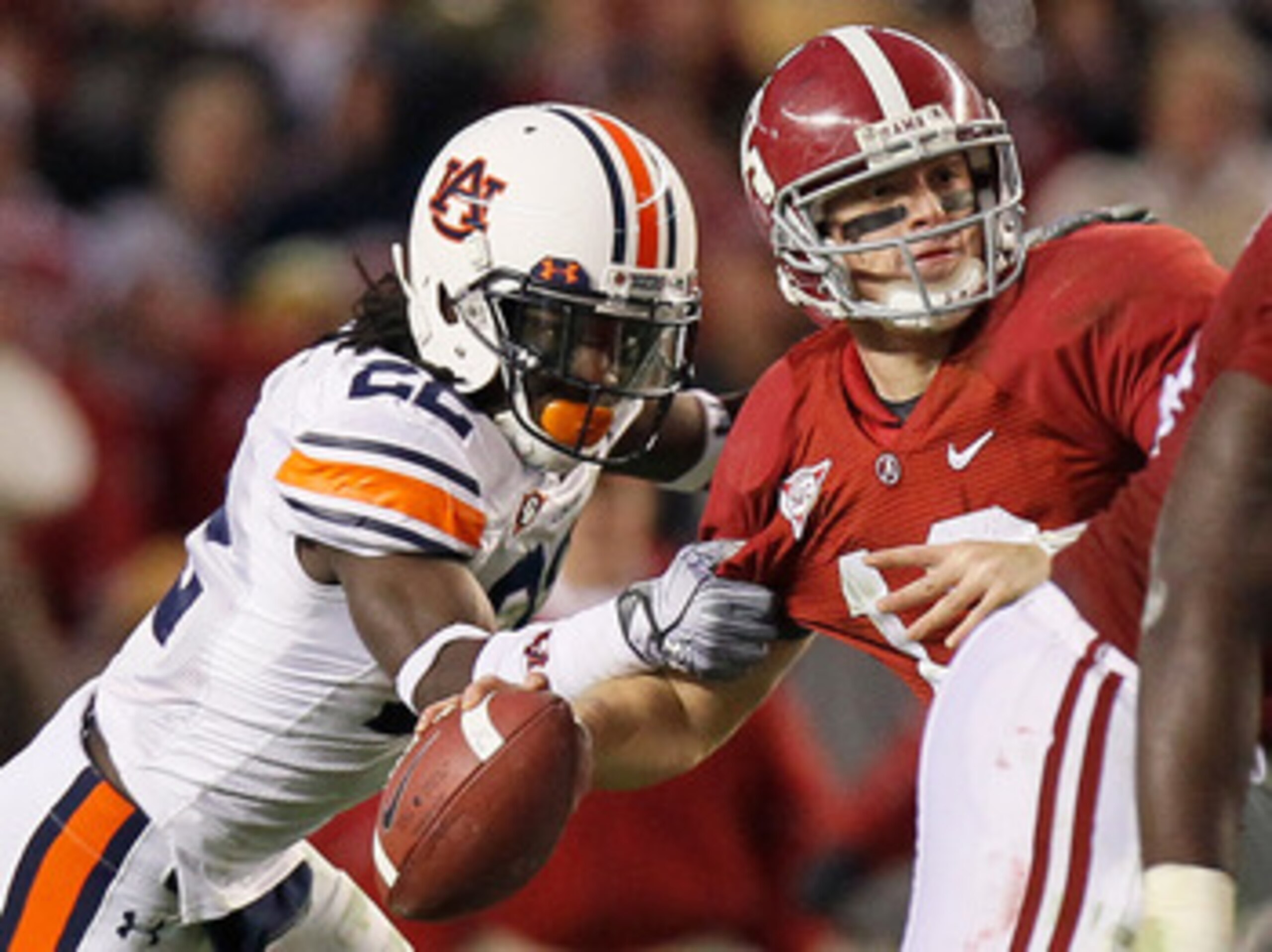 TUSCALOOSA, AL - NOVEMBER 26:  T'Sharvan Bell #22 of the Auburn Tigers sacks quarterback Greg McElroy #12 of the Alabama Crimson Tide at Bryant-Denny Stadium on November 26, 2010 in Tuscaloosa, Alabama.  McElroy was injured on this sack.  (Photo by Kevin 