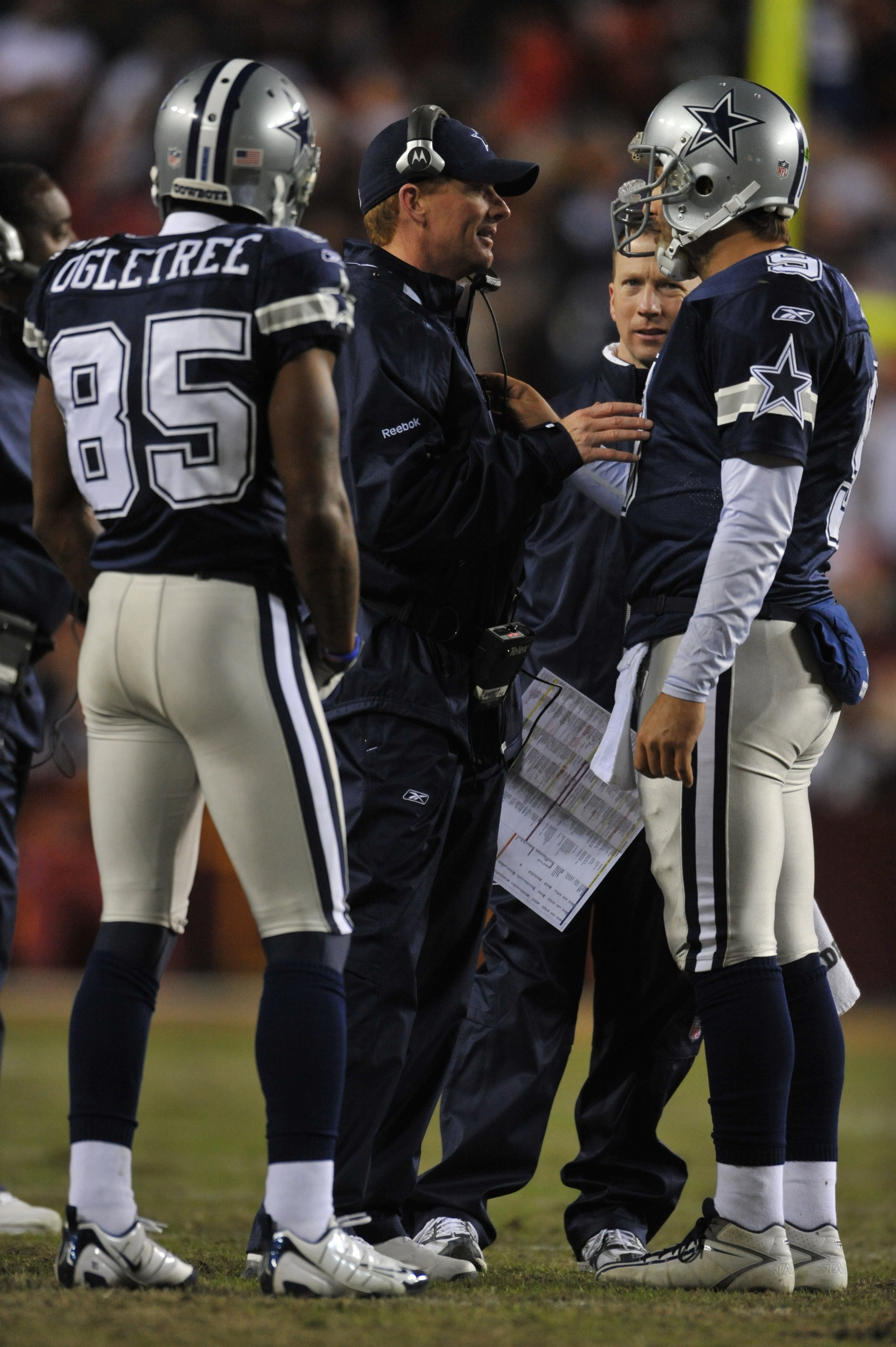 LANDOVER, MD - DECEMBER 27:  Assistant head coach Jason Garrett of the Dallas Cowboys speaks with Tony Romo #9 during the game against the Washington Redskins at FedExField on December 27, 2009 in Landover, Maryland. The Cowboys defeated the Redskins 17-0
