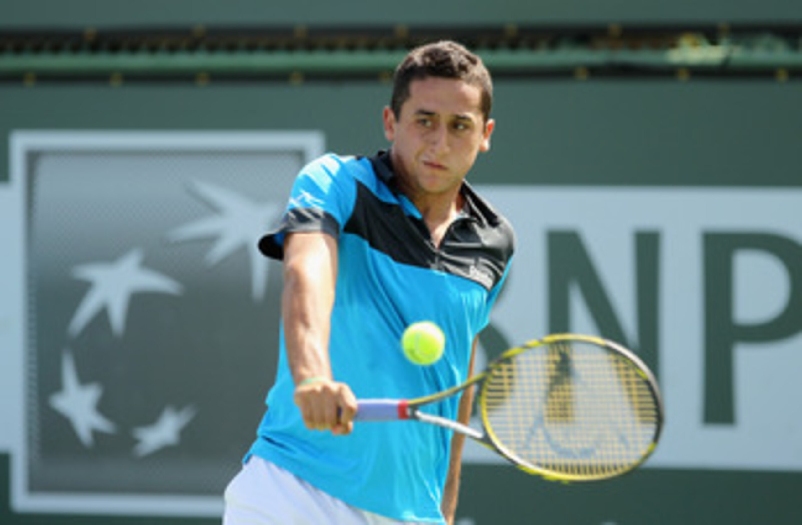 INDIAN WELLS, CA - MARCH 14:  Nicolas Almagro of Spain returns a shot to Albert Montanes of Spain during the BNP Paribas Open at the Indian Wells Tennis Garden on March 14, 2011 in Indian Wells, California.  (Photo by Ezra Shaw/Getty Images)