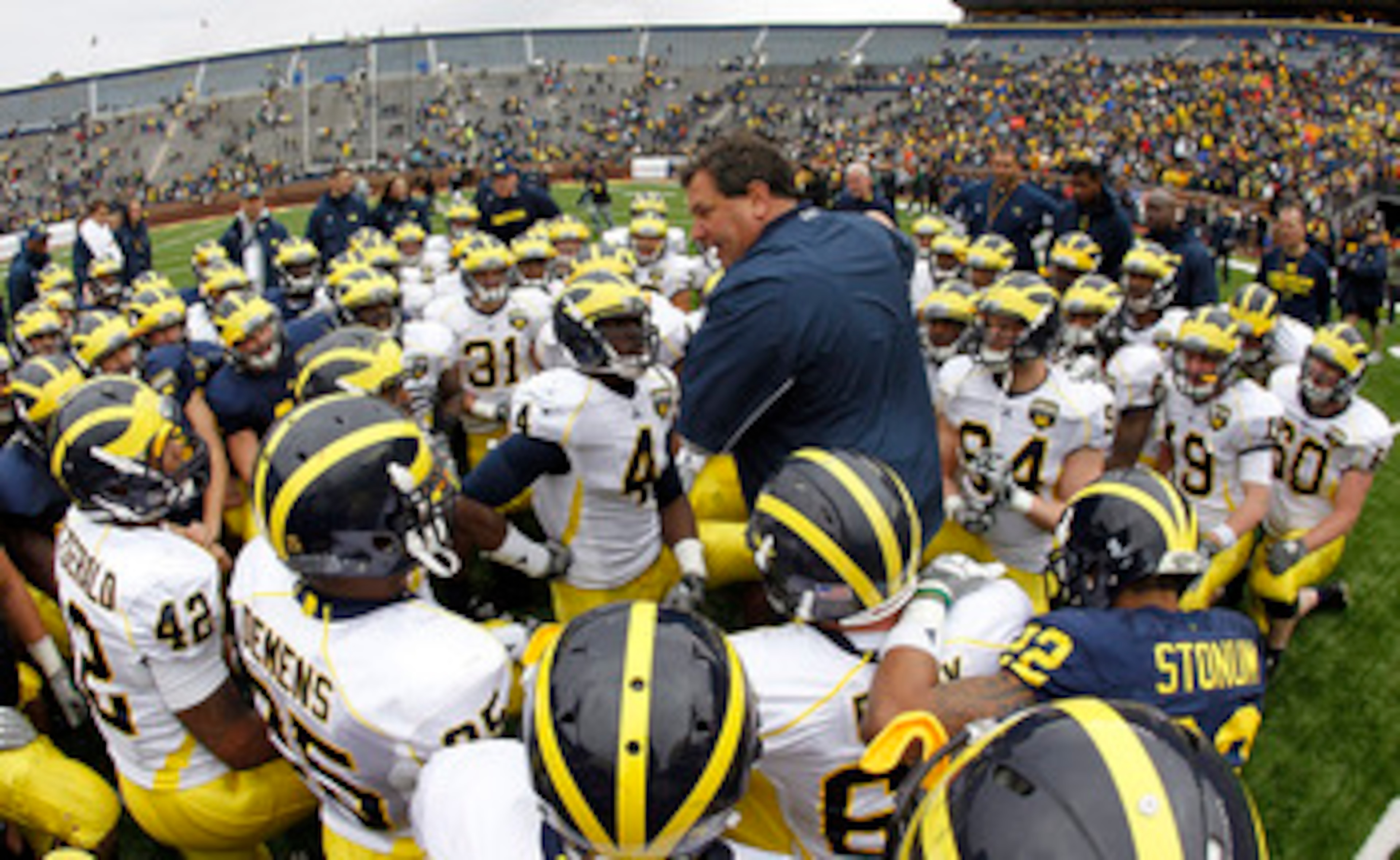 ANN ARBOR, MI - APRIL 16:  Head football coach Brady Hoke talks with his team during the annual Spring Game at Michigan Stadium on April 16, 2011 in Ann Arbor, Michigan.  (Photo by Leon Halip/Getty Images)