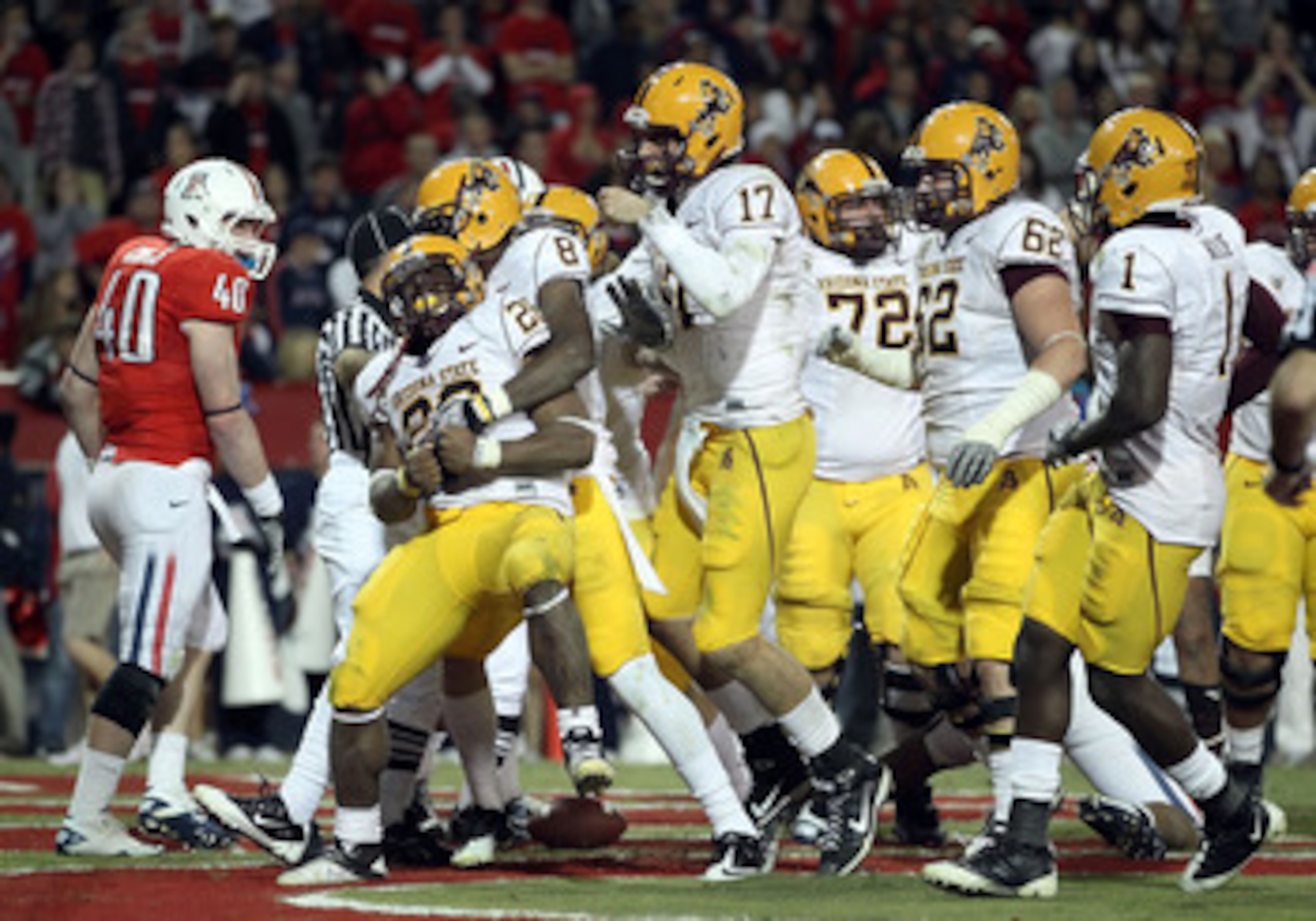 TUCSON, AZ - DECEMBER 02:  Quarterback Brock Osweiler #17 of the Arizona State Sun Devils celebrates with Cameron Marshall #26 after he scored a rushing touchdown against the Arizona Wildcats during the double overtime of the college football game at Ariz