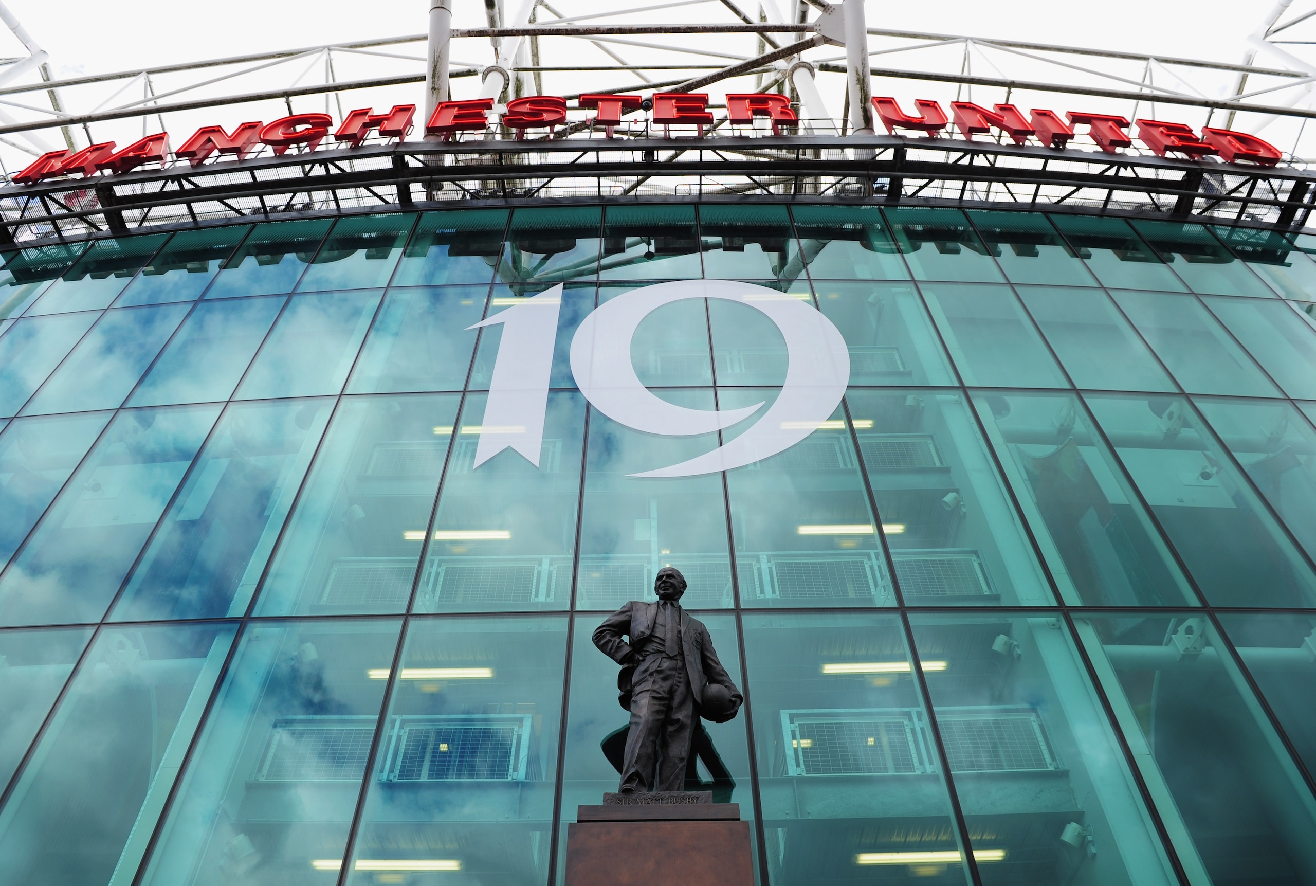 MANCHESTER, ENGLAND - MAY 22:  Signage depicting Manchester United's 19th Championship title above the statue of Sir Matt Busby prior the Barclays Premier League match between Manchester United and Blackpool at Old Trafford on May 22, 2011 in Manchester,