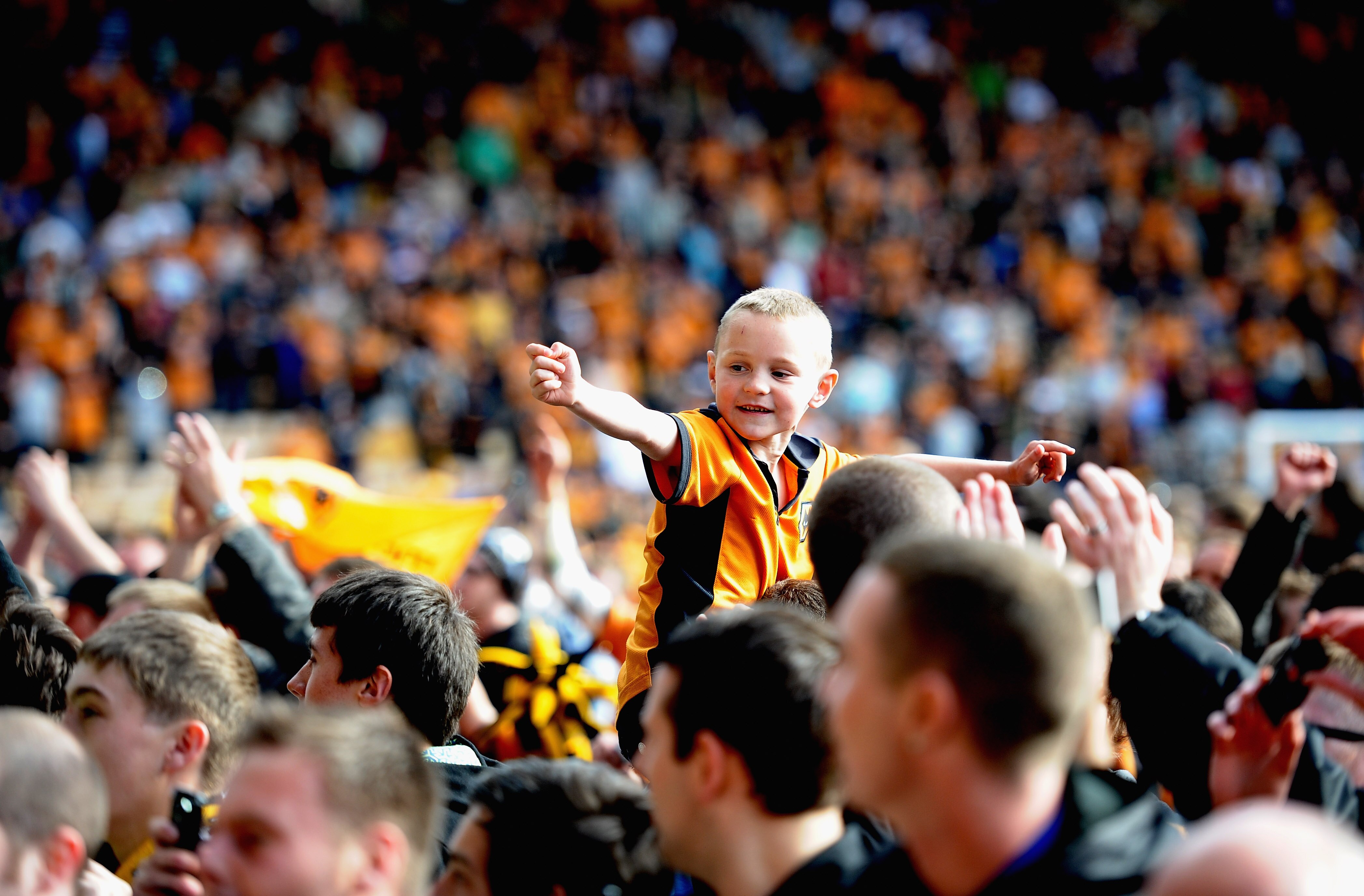 WOLVERHAMPTON, ENGLAND - MAY 22:  A young Wolves fan celebrates on the pitch after watching his side avoid relagation during the Barclays Premier League match between Wolverhampton Wanderers and Blackburn Rovers at Molineux on May 22, 2011 in Wolverhampto