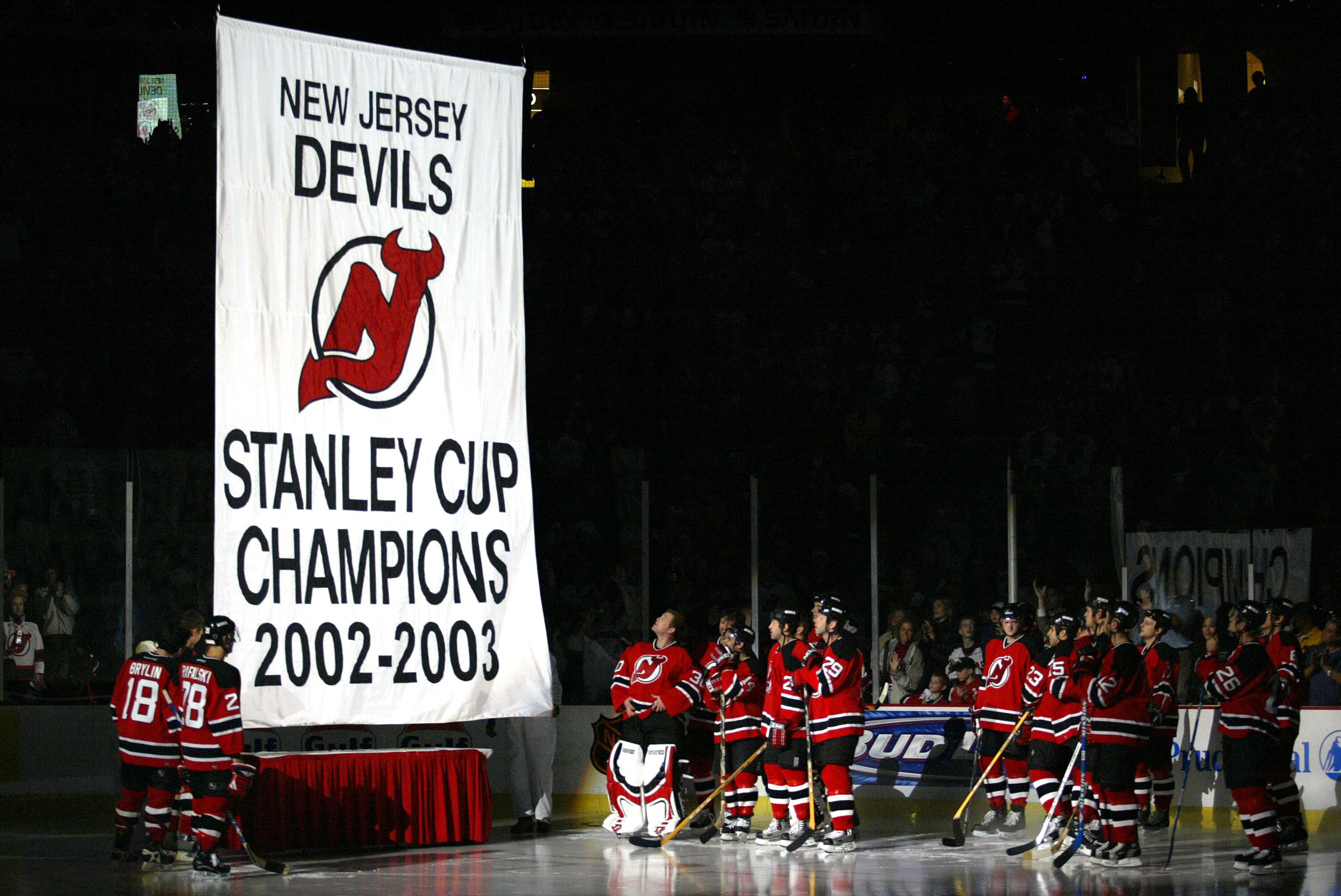 EAST RUTHERFORD, NJ - OCTOBER 16: The New Jersey Devils watch the raising of the banner representing their 2002-2003 Stanley Cup Championship Season before the game against the Toronto Maple Leafs October 16, 2003 at the Continental Arena in East Ruther EAST RUTHERFORD, NJ - OCTOBER 16: The New Jersey Devils watch the raising of the banner representing their 2002-2003 Stanley Cup Championship Season before the game against the Toronto Maple Leafs October 16, 2003 at the Continental Arena in East Ruther